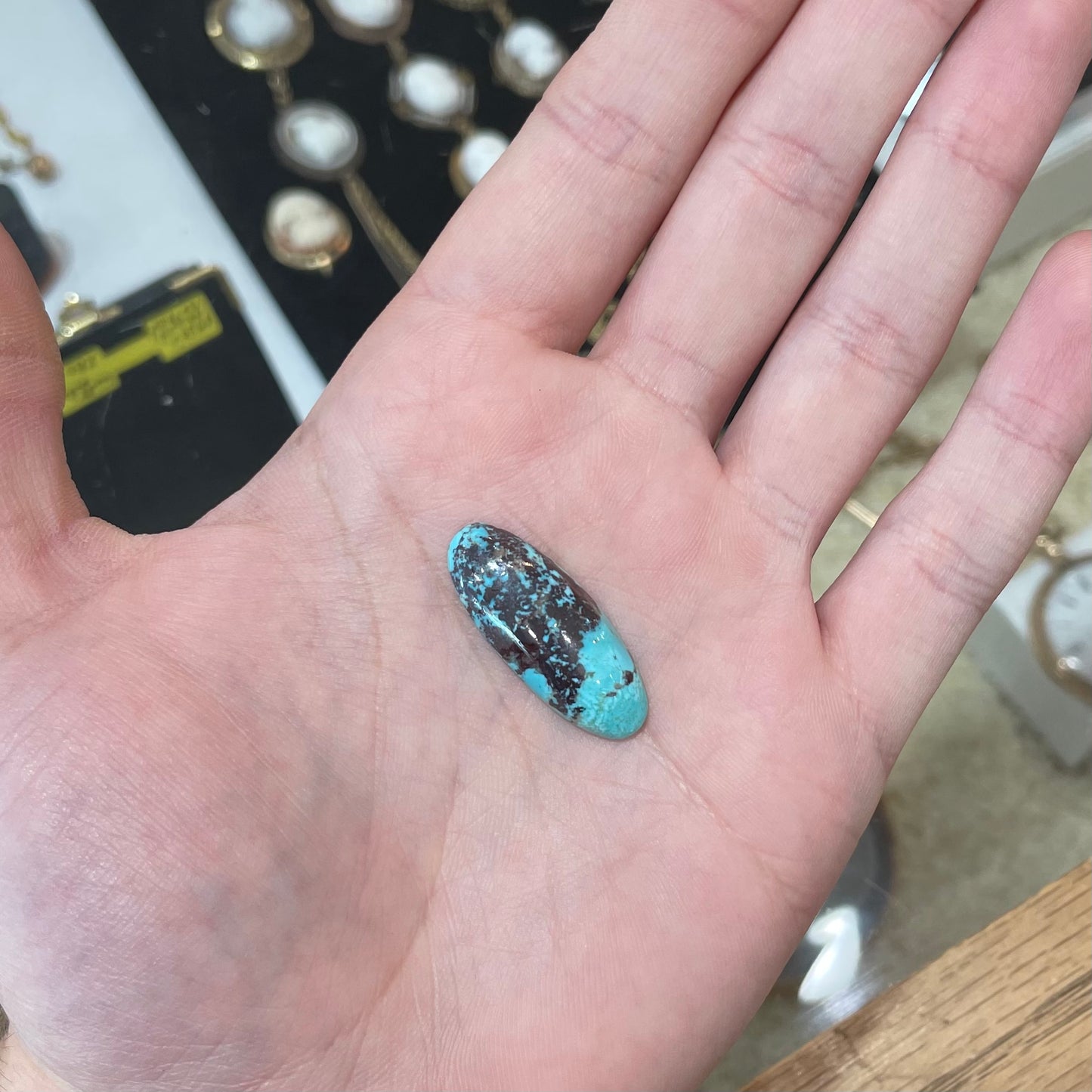 A loose, oval cabochon cut blue and red matrix turquoise stone from Royston District, Nevada.