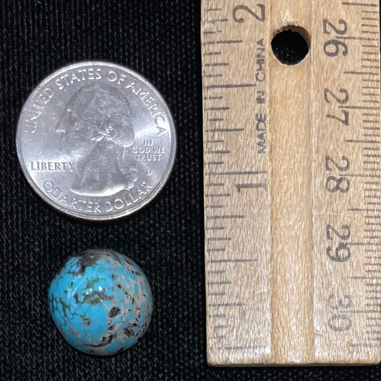 A loose, multicolored, round cabochon cut turquoise stone from Valley Blue Mine in Lander County, Nevada.