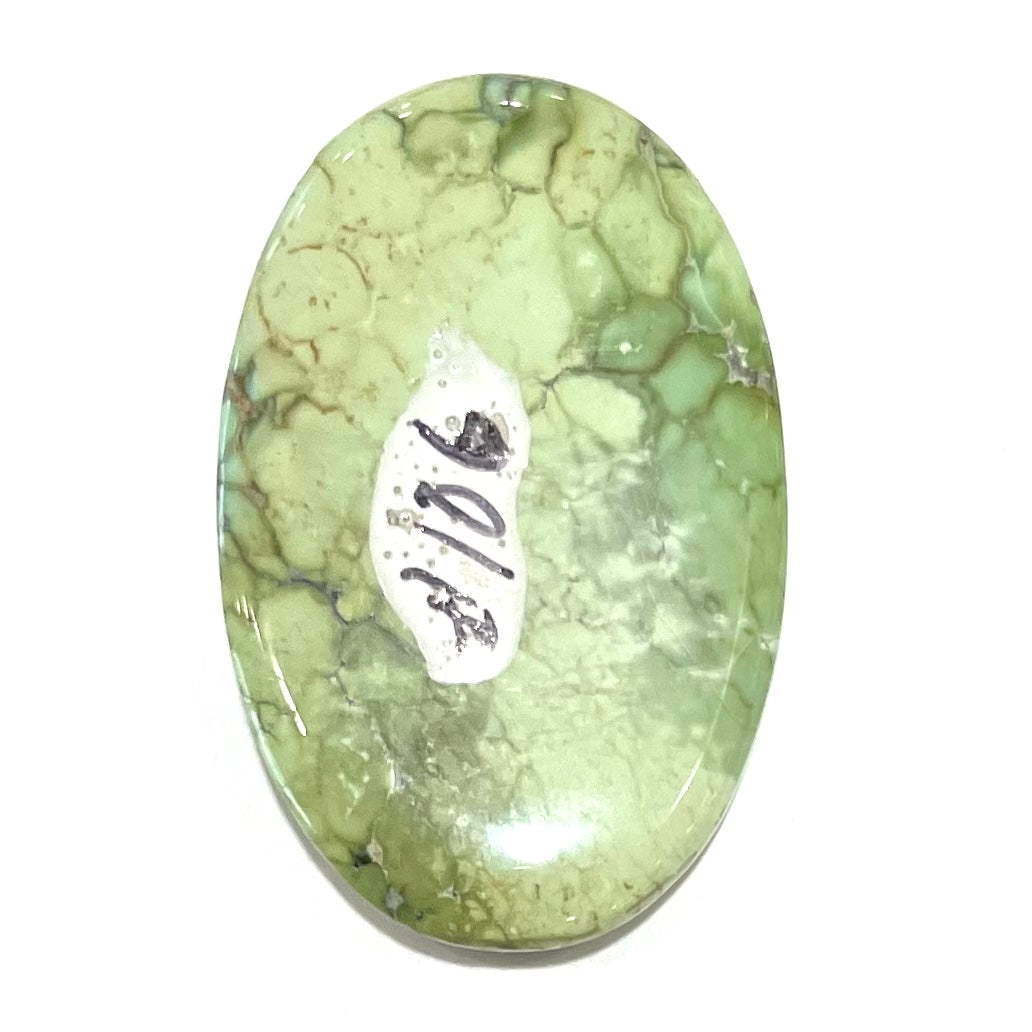 A loose, green turquoise stone cabochon from the Number 8 Mine.