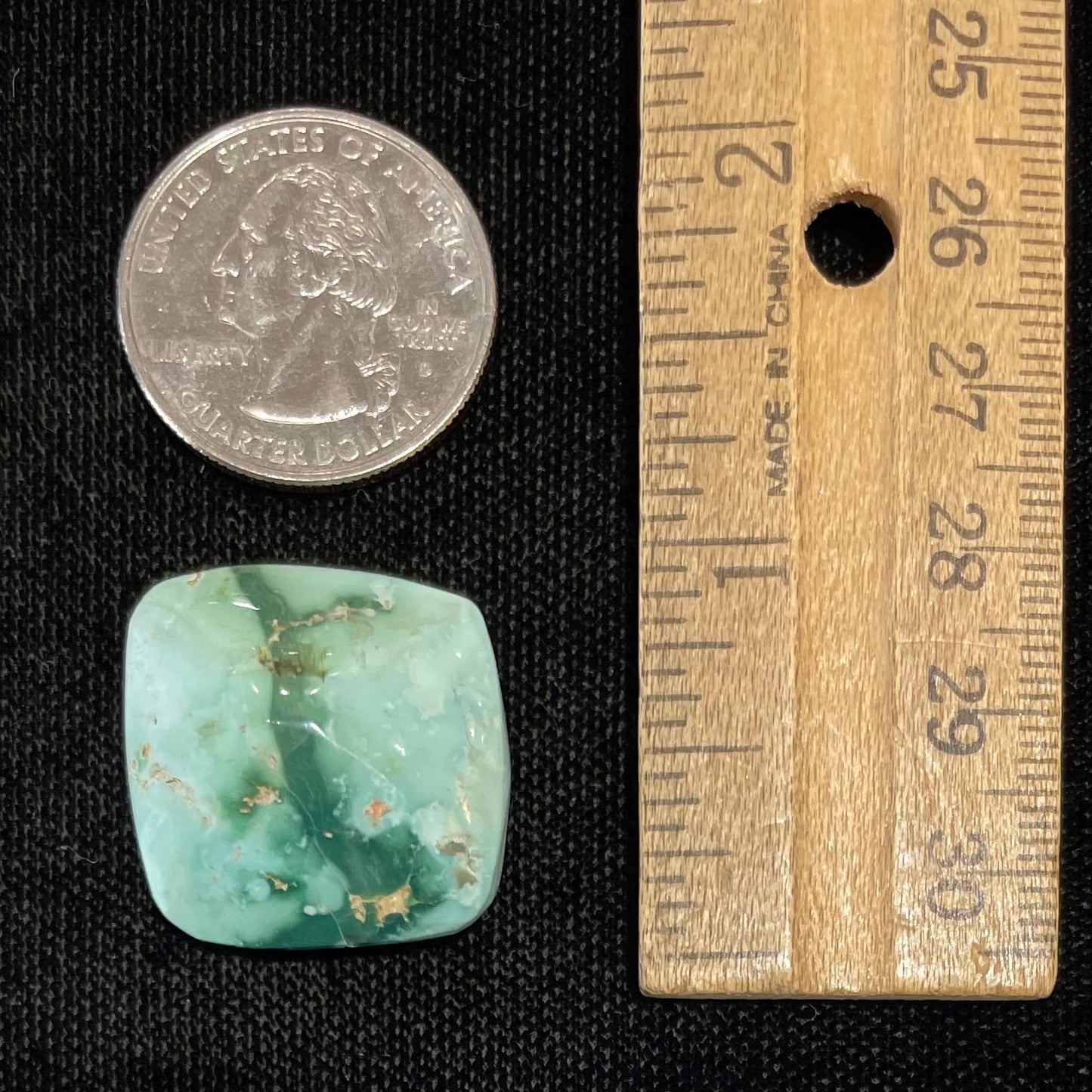 A loose, cushion cabochon cut variscite stone from Utah, USA.