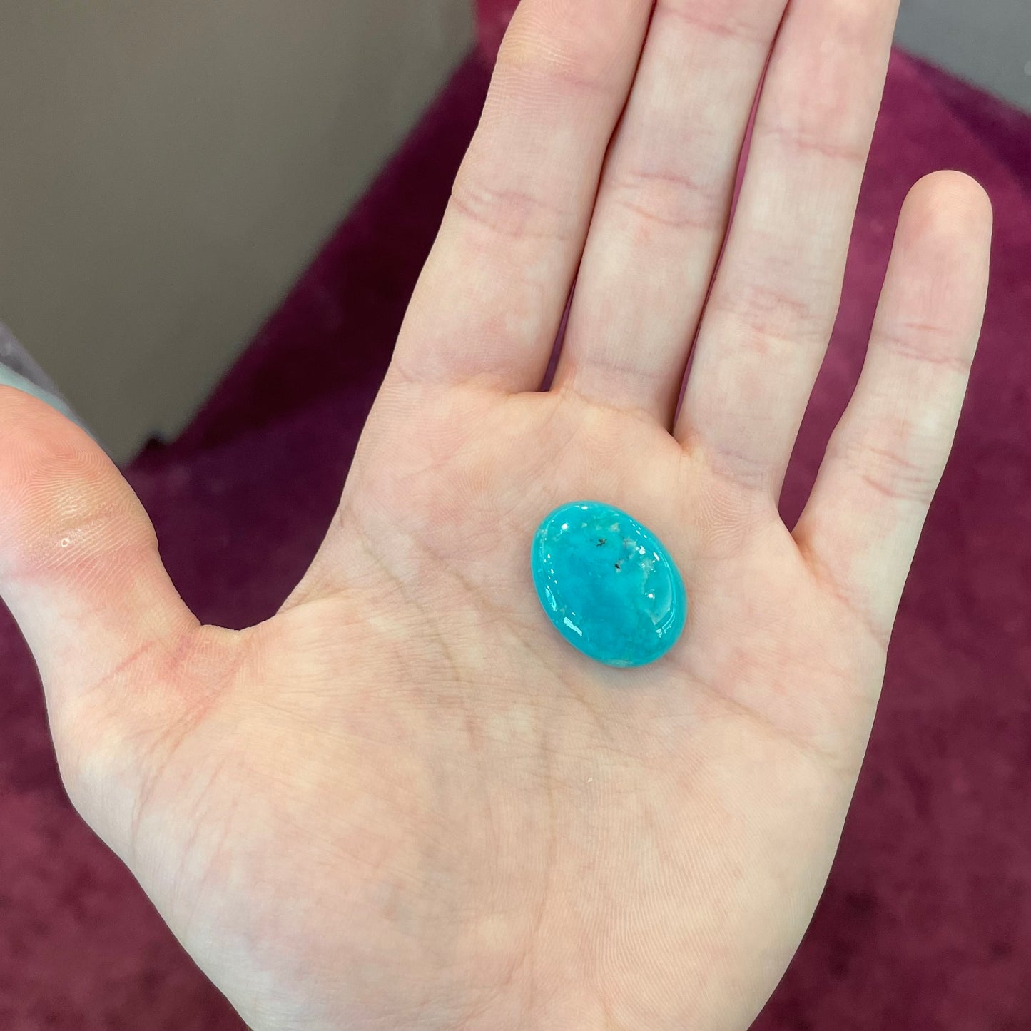 A loose, oval cabochon cut blue turquoise stone from Royston Mining District, Nevada.