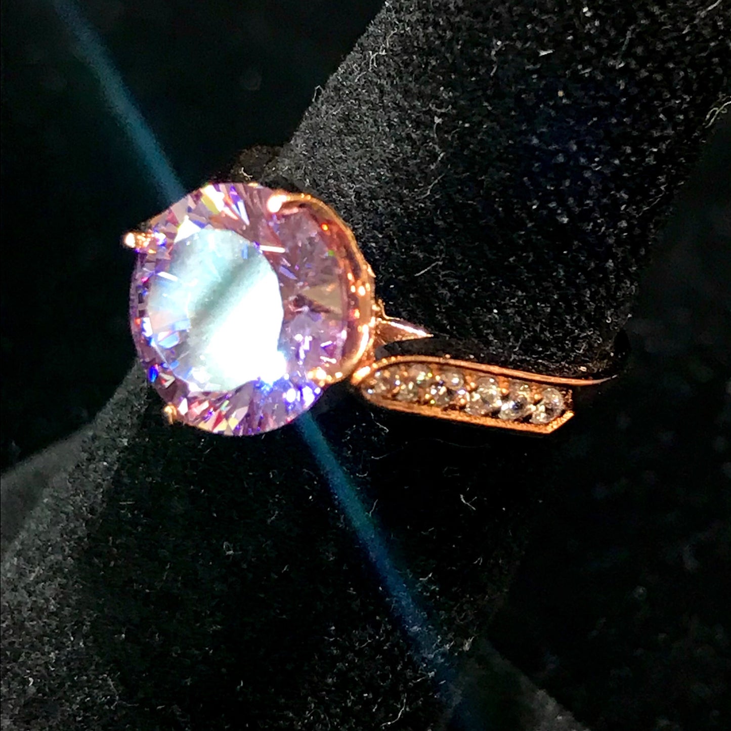 Purple CZ ring with white CZ side stones. Rose gold plated over sterling silver.