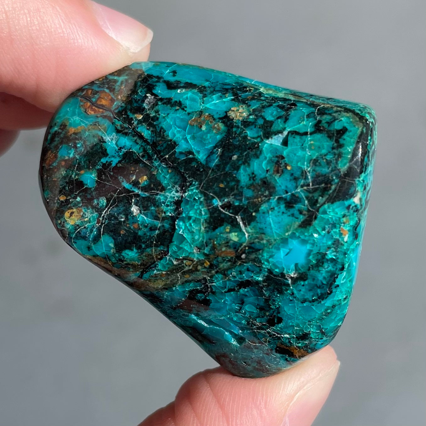 A polished freeform shaped chrysocolla specimen.