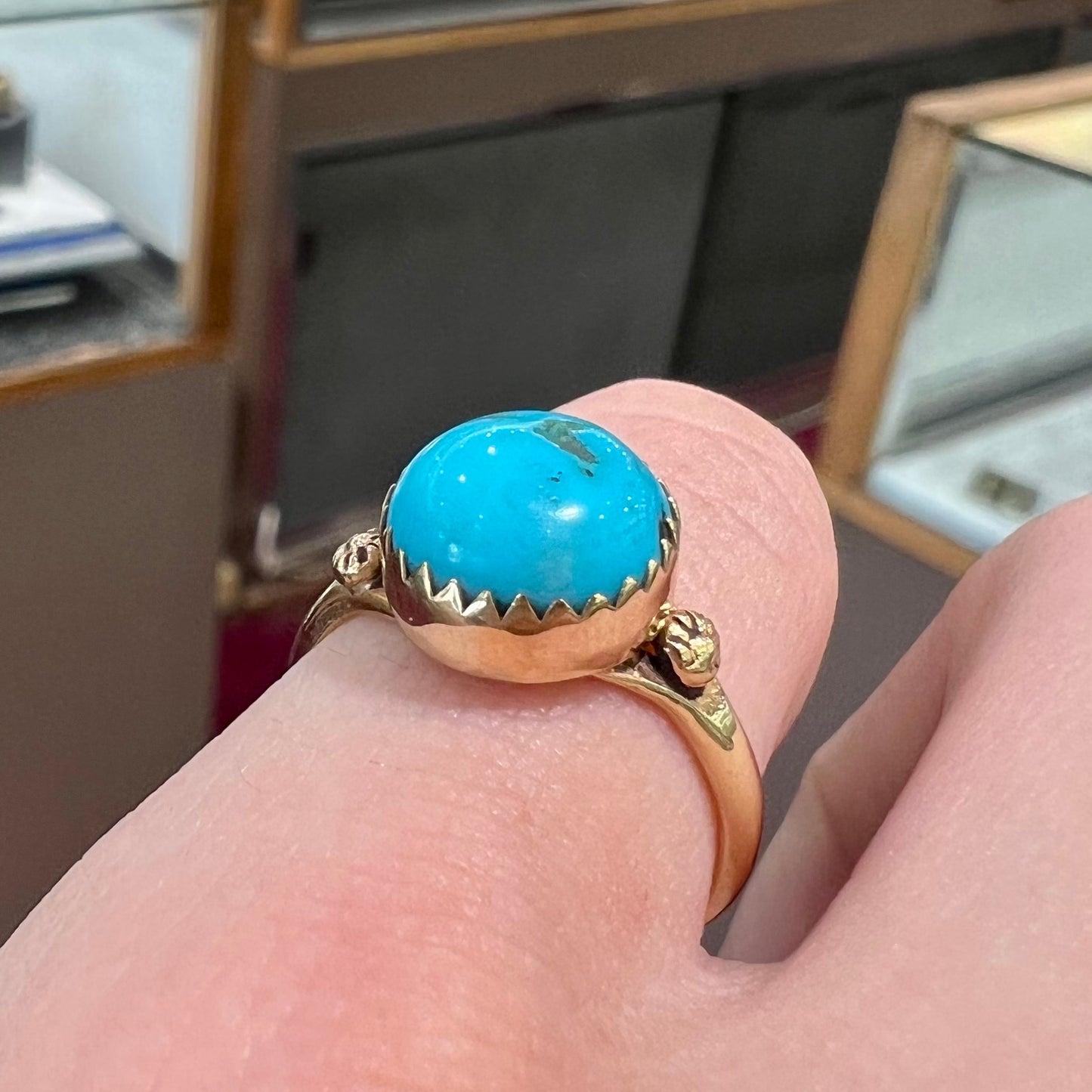 A ladies' yellow gold turquoise ring. The turquoise is a round cabochon cut.