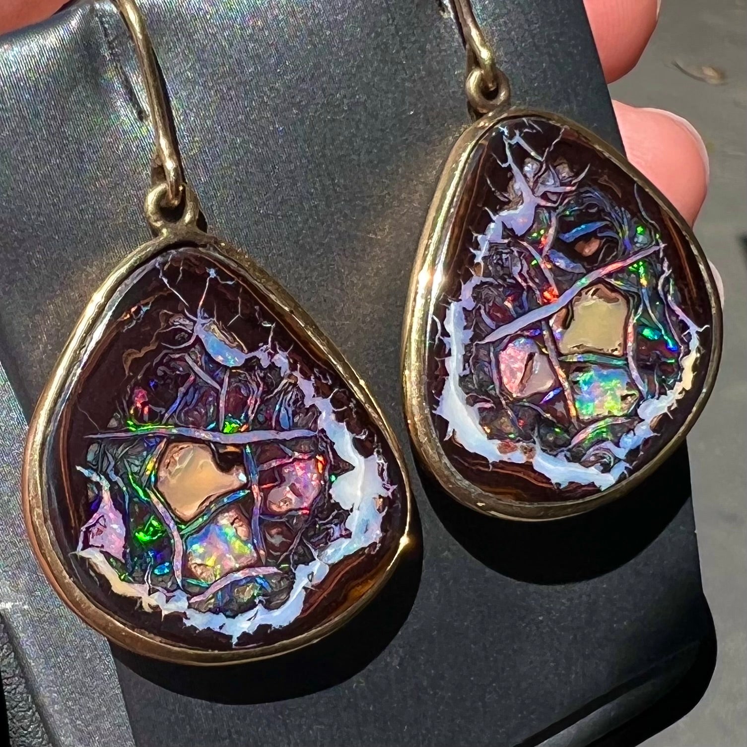 A pair of yellow gold bezel set Yowah nut boulder opal dangle earrings.