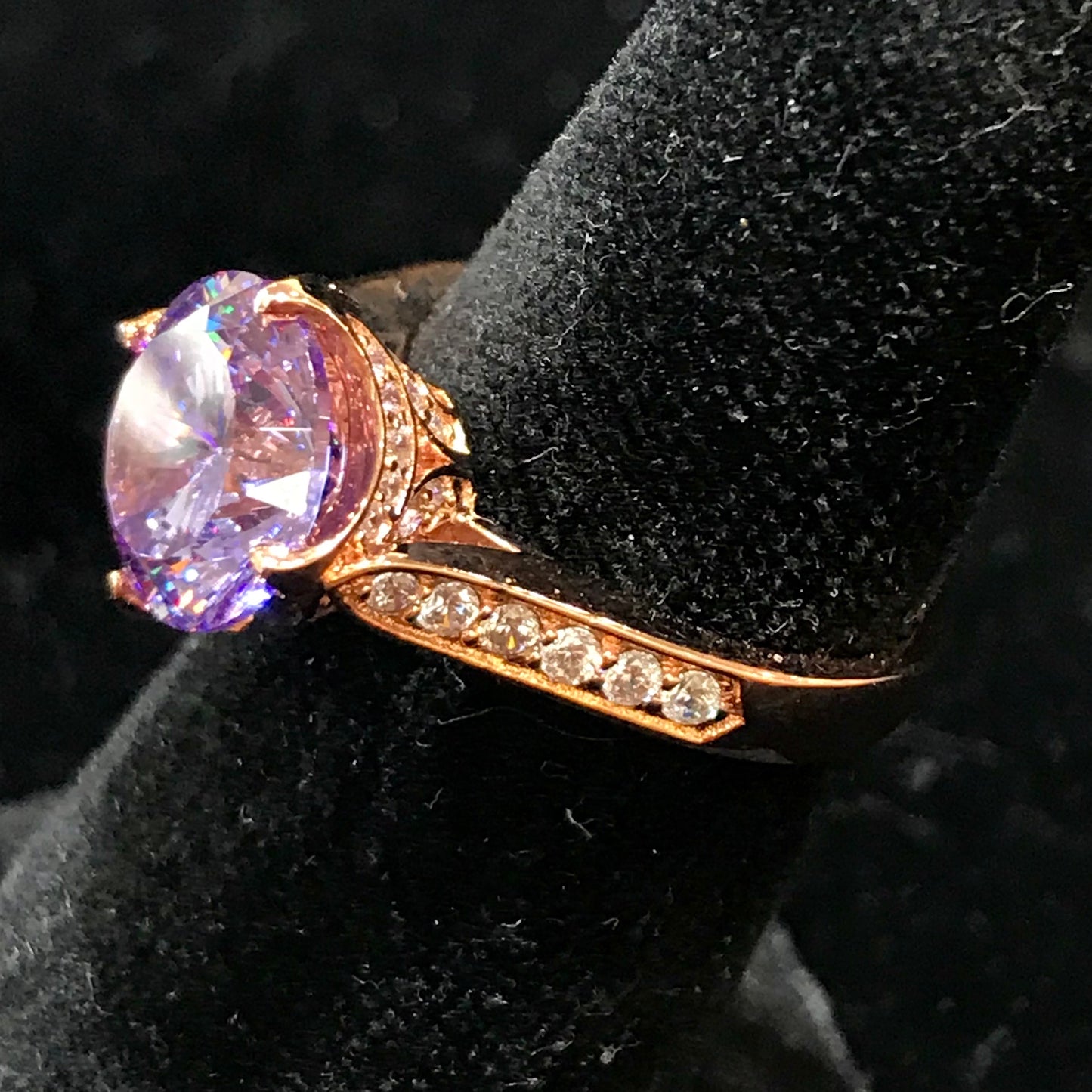 Purple CZ ring with white CZ side stones. Rose gold plated over sterling silver.