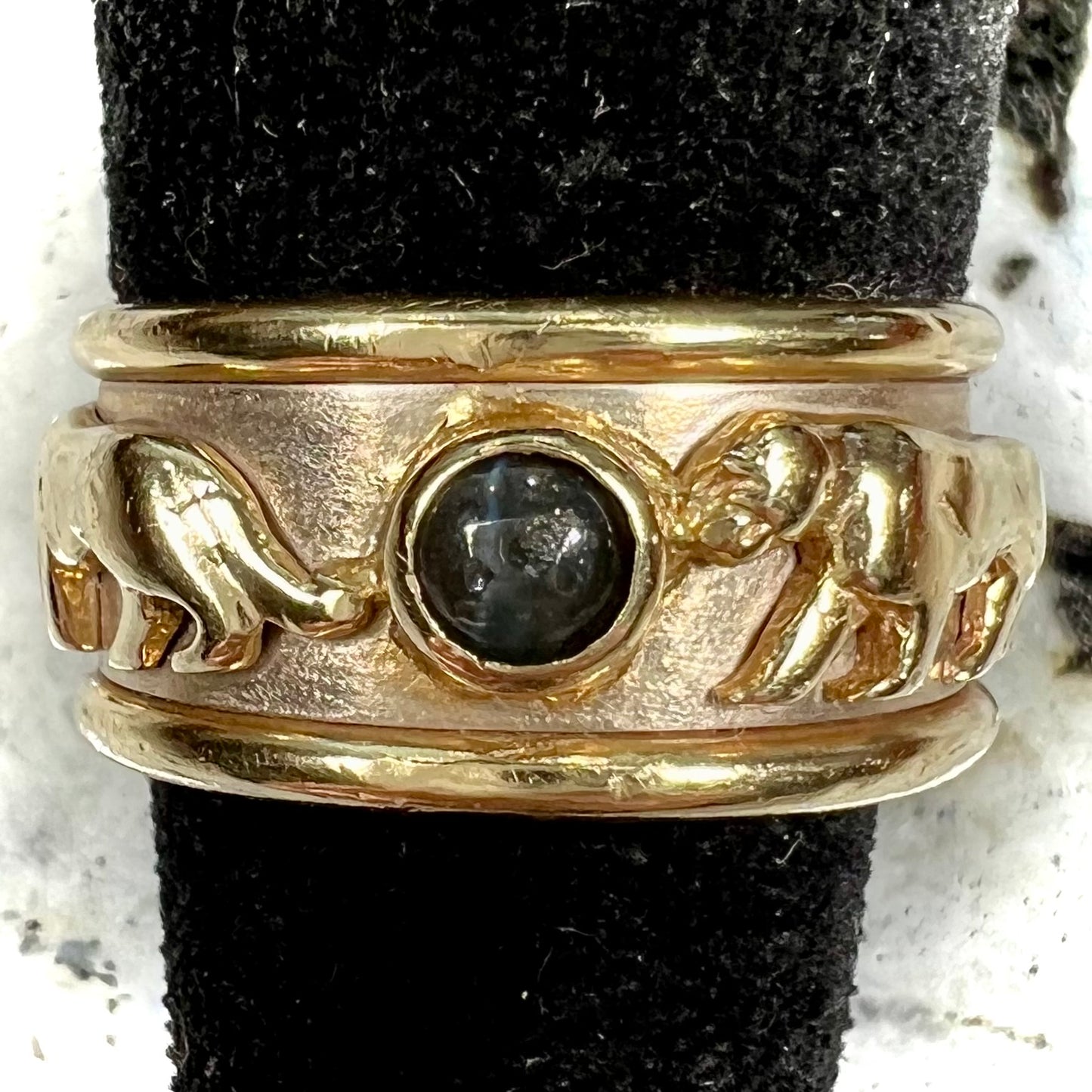 Men's gold ring set with three cabochon cut cat's eye alexandrite stones and panther designs.