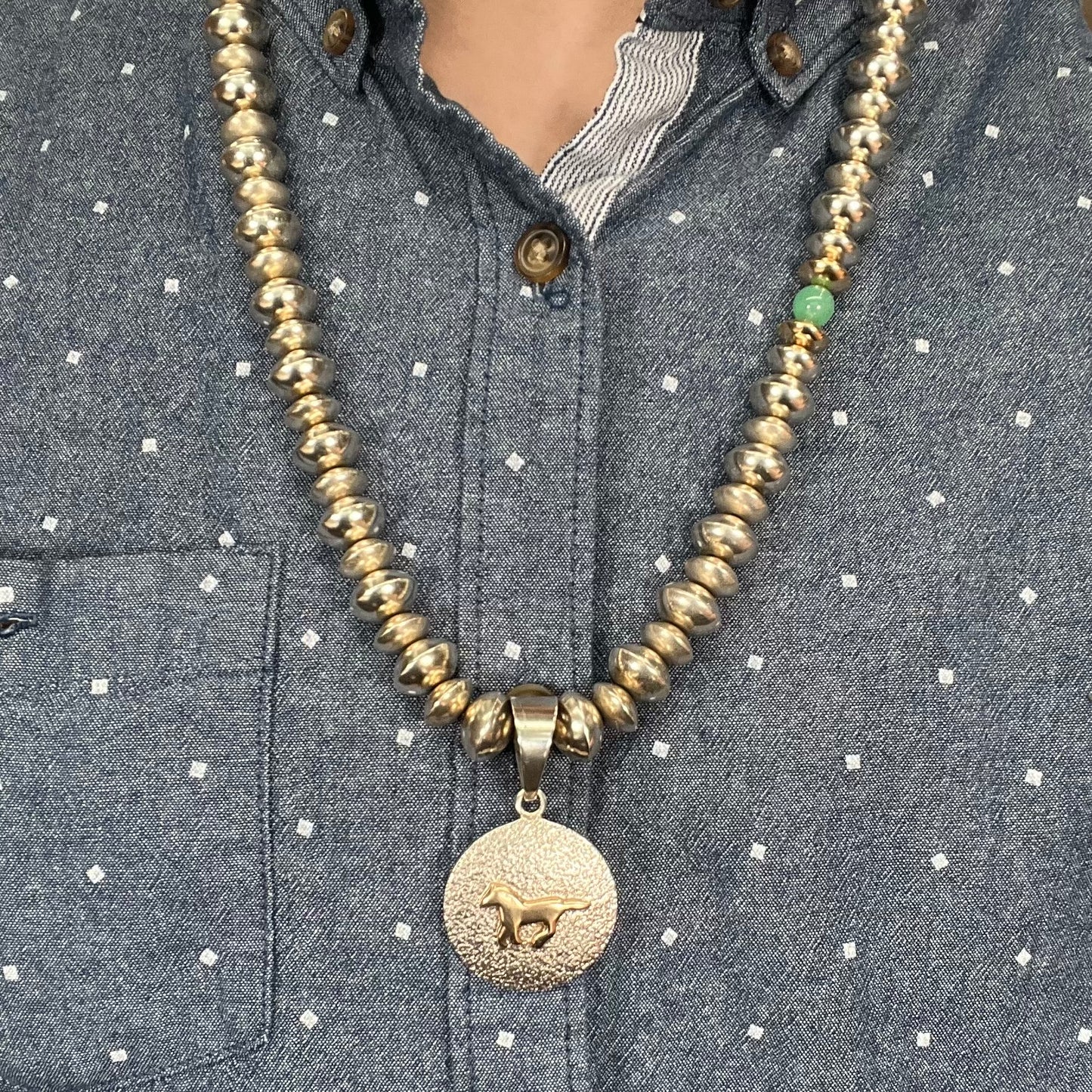 A silver, gold, and chrysoprase bead necklace handmade by Navajo artist, Alfred Joe.