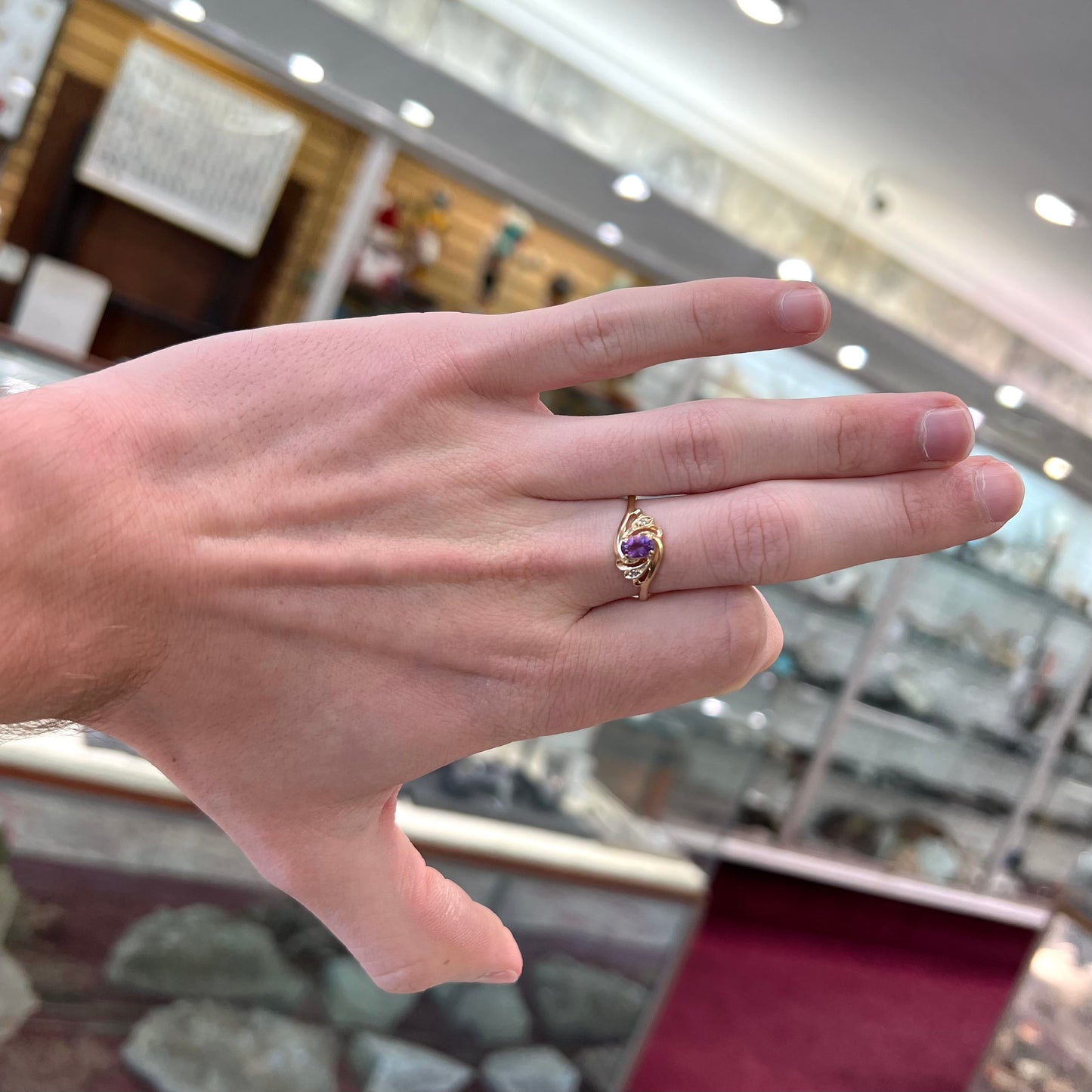 A yellow gold oval cut amethyst and diamond accent ladies' ring.