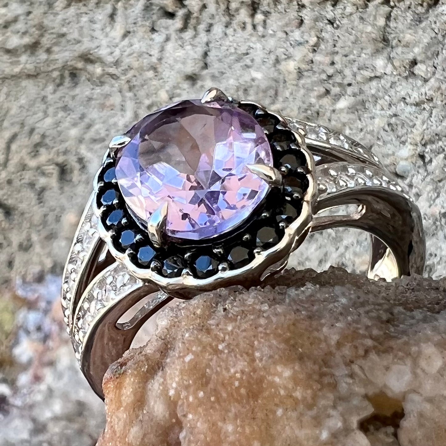 Sterling silver ladies' ring made with Rose de France amethyst set in a black spinel halo with white topaz accents.