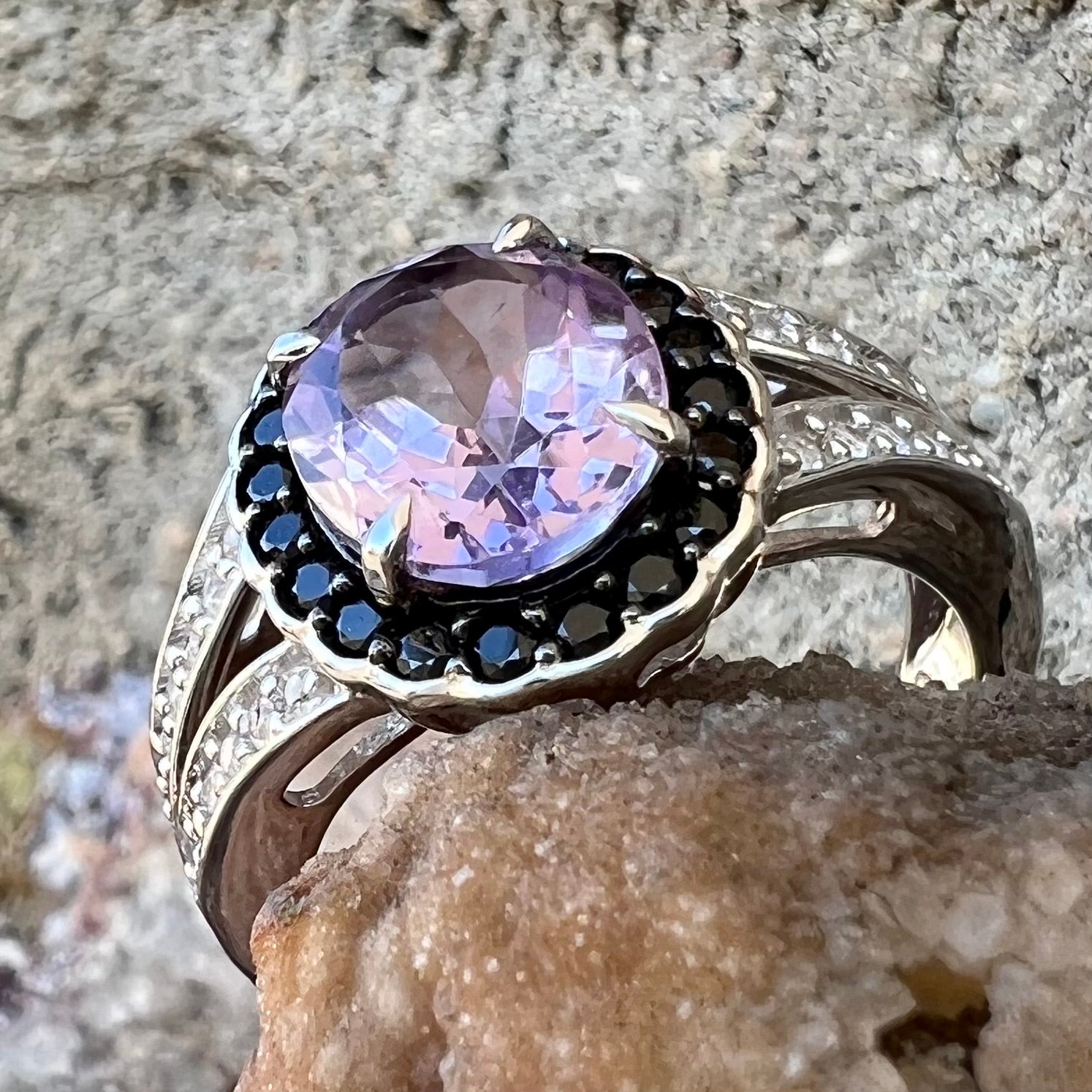 Sterling silver ladies' ring made with Rose de France amethyst set in a black spinel halo with white topaz accents.