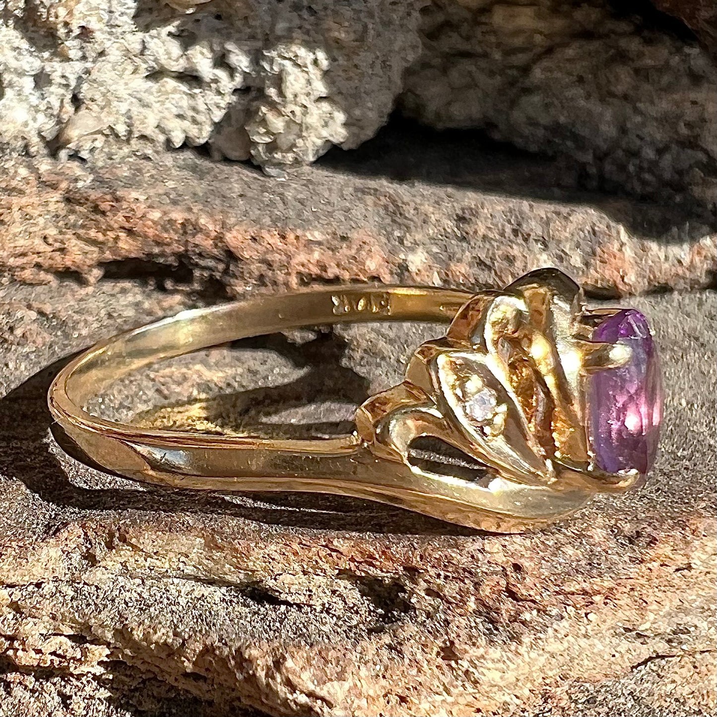 A yellow gold oval cut amethyst and diamond accent ladies' ring.