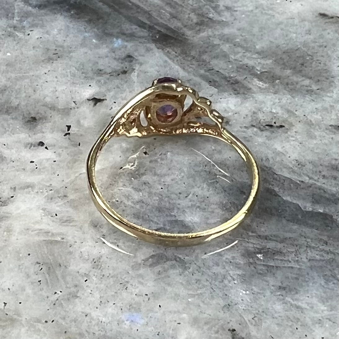 A yellow gold oval cut amethyst and diamond accent ladies' ring.
