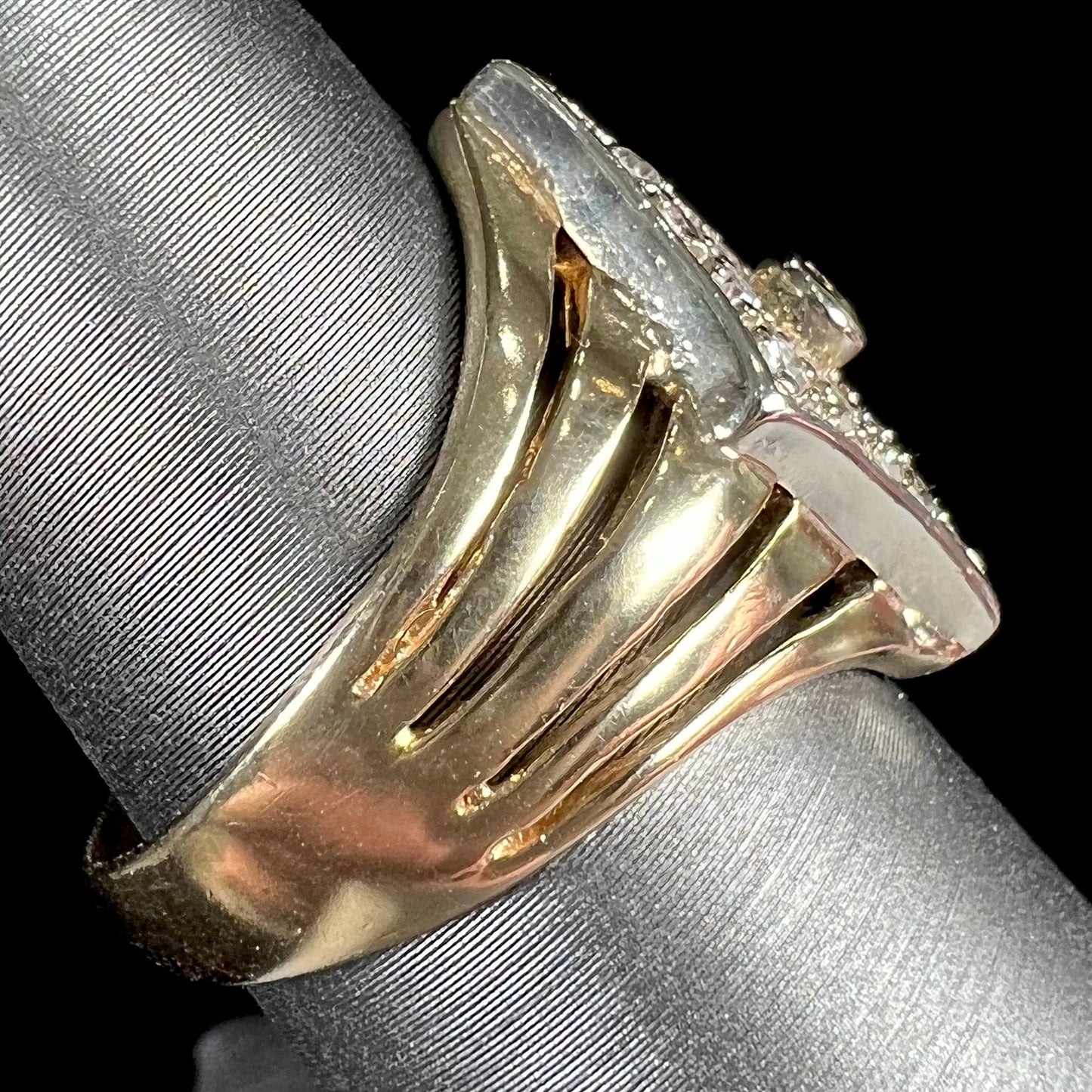 An estate ladies' gold diamond ring. The shape of the ring resembles an art deco style diamond.