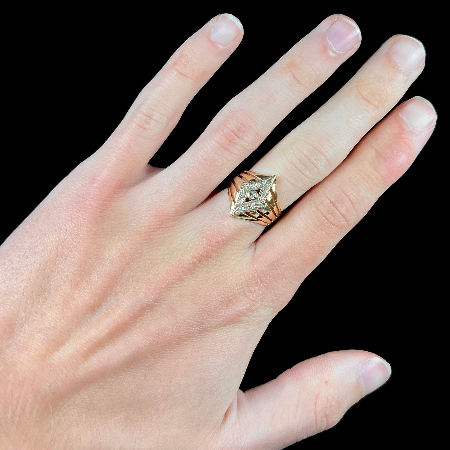 An estate ladies' gold diamond ring. The shape of the ring resembles an art deco style diamond.