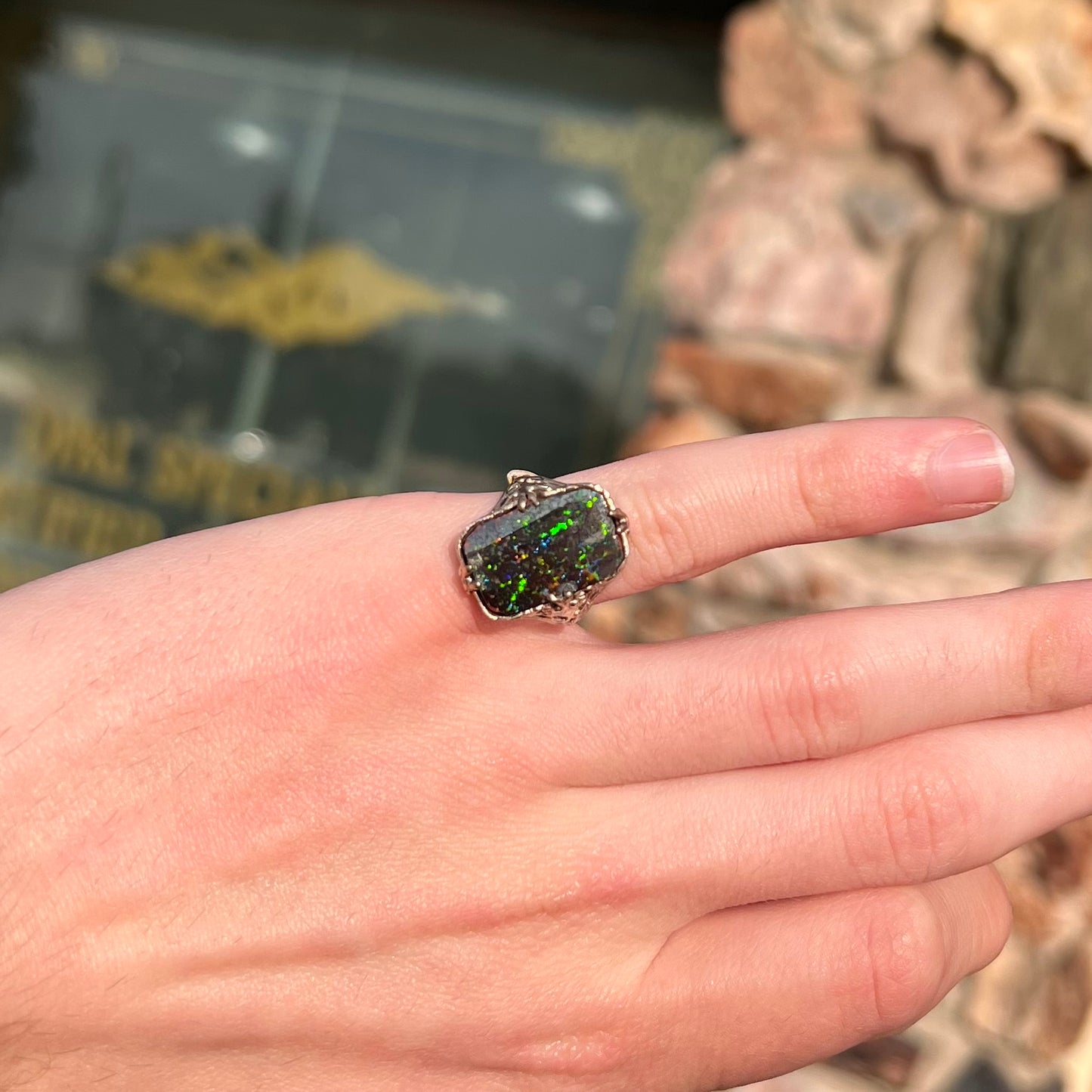 A vintage, white gold filigree unisex ring set with a black Koroit boulder opal.