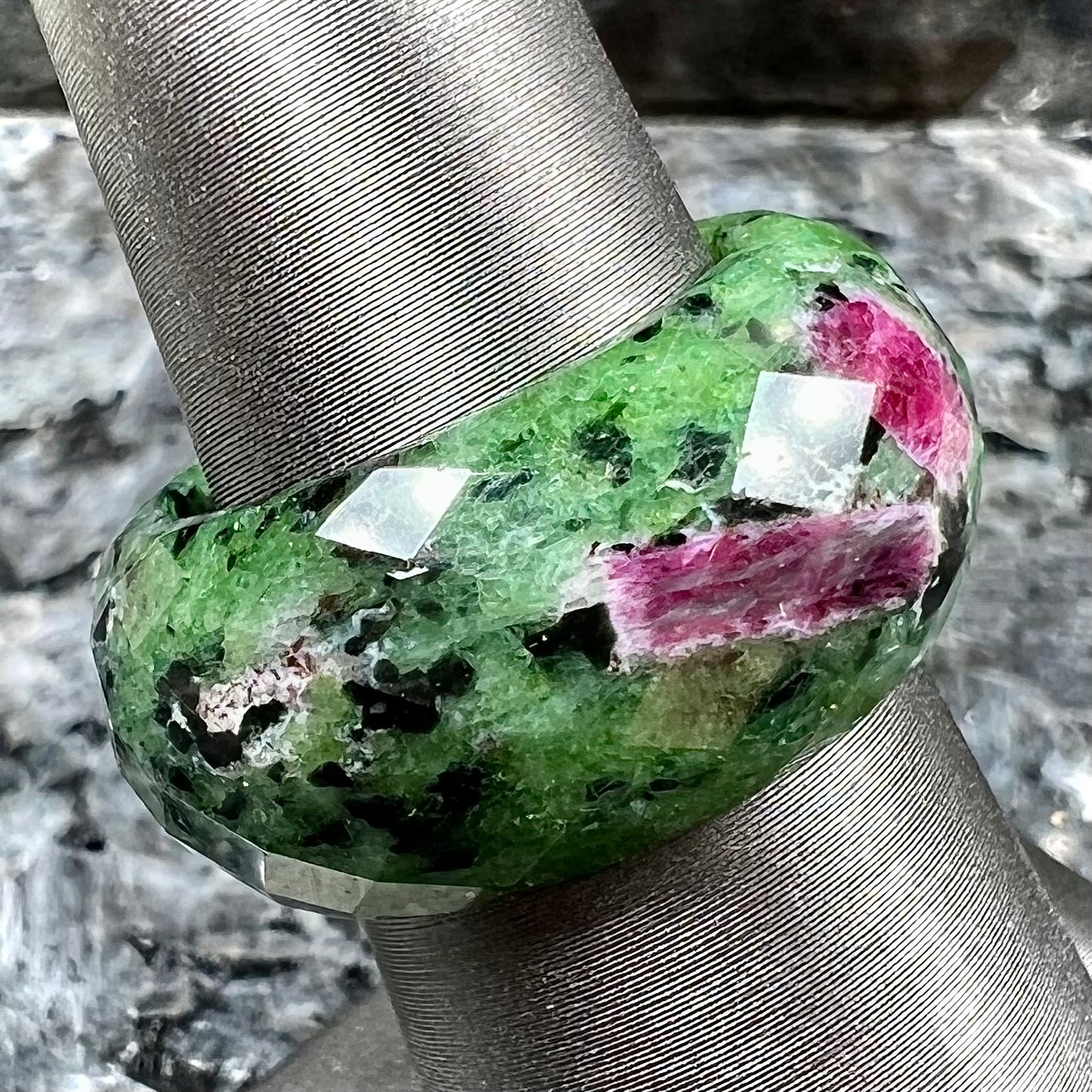 A faceted, carved stone ring made form ruby in zoisite.