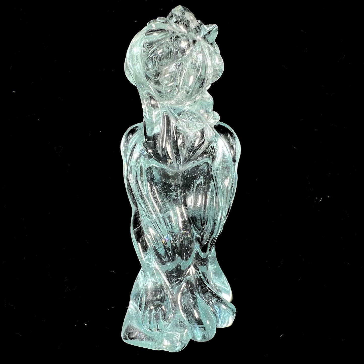 A stone woman figure carved from a blue aquamarine crystal.  The piece resembles Venus Gummi de Milo.