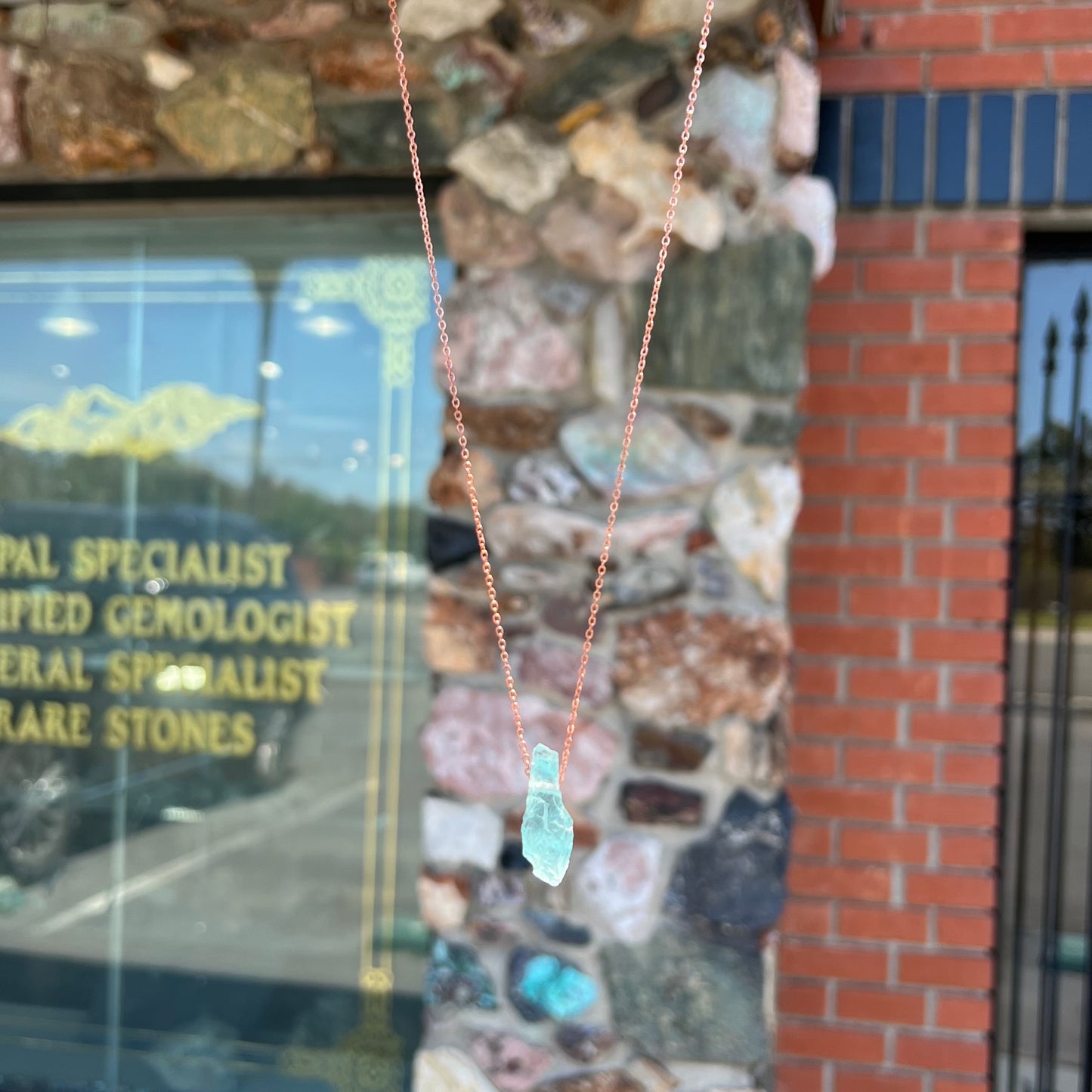A drilled aquamarine crystal necklace on a copper cable chain.
