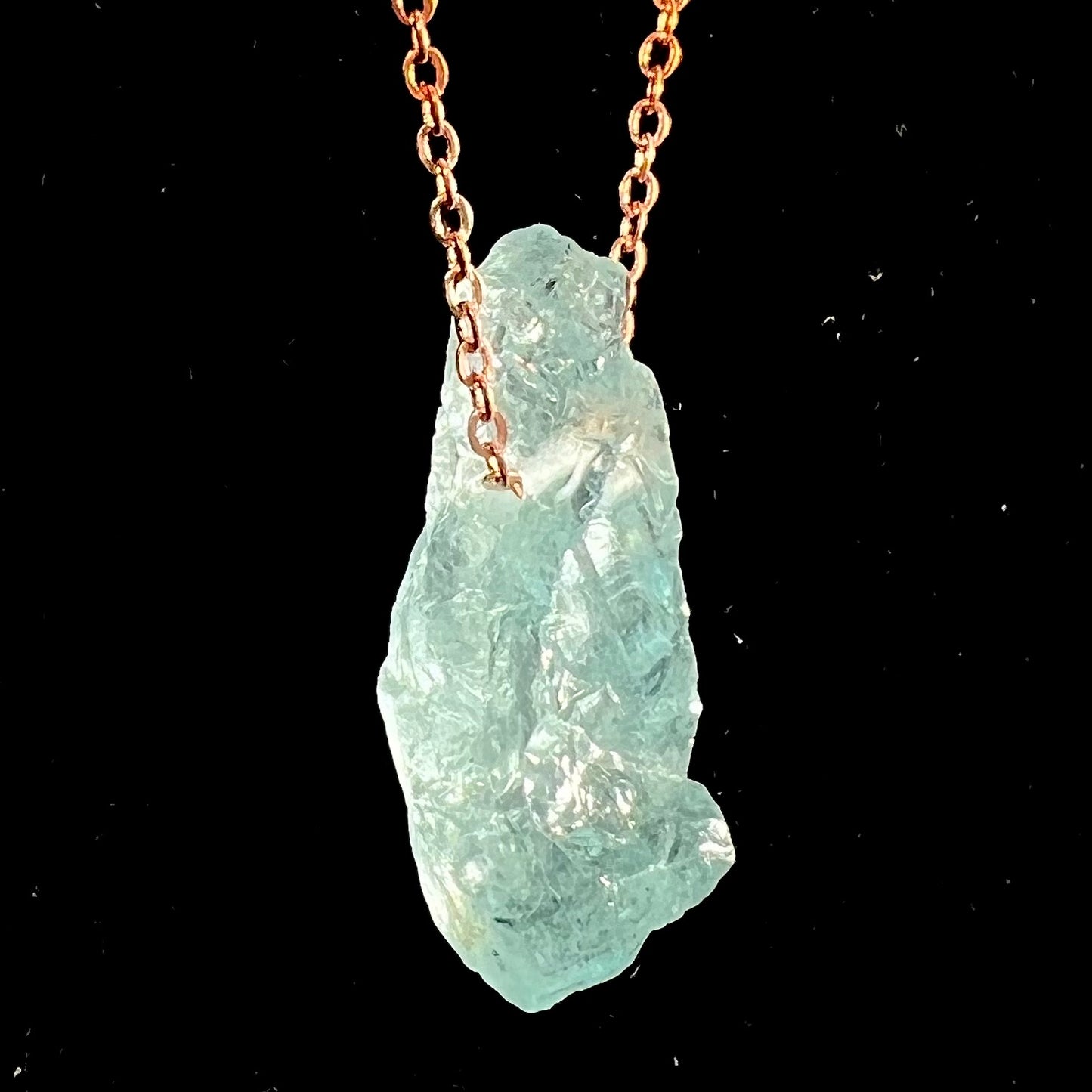 A drilled aquamarine crystal necklace on a copper cable chain.