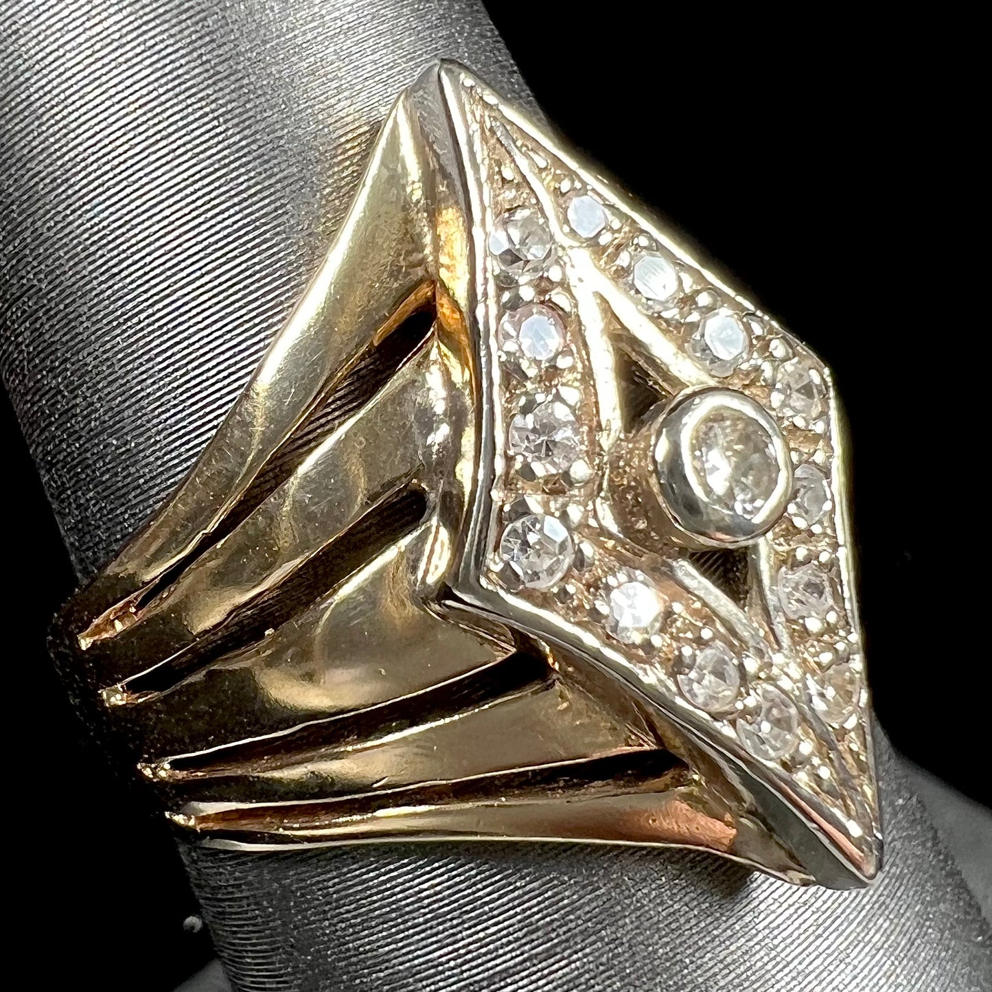 An estate ladies' gold diamond ring. The shape of the ring resembles an art deco style diamond.