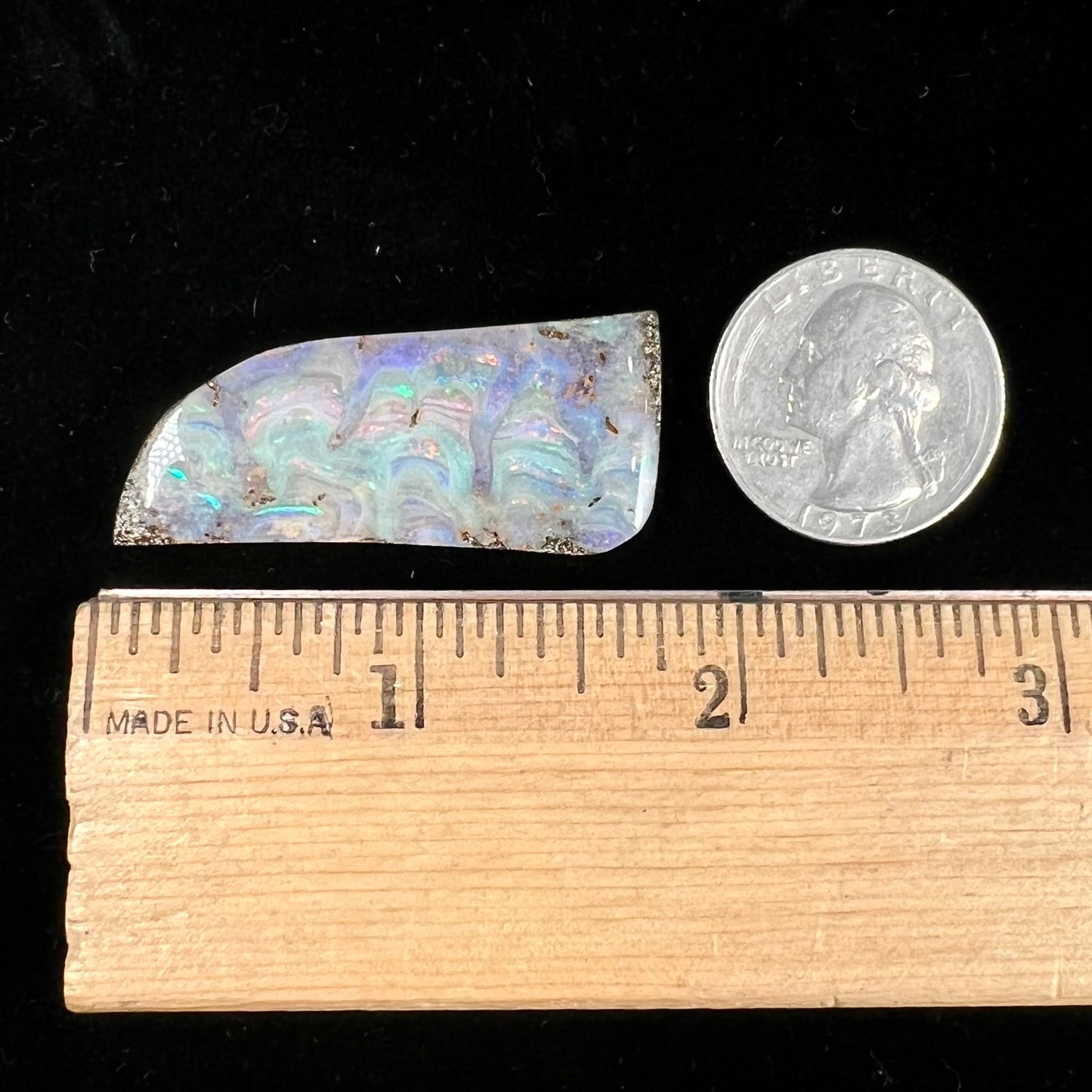 A loose, freeform cut, natural boulder opal stone from Quilpie, Australia.