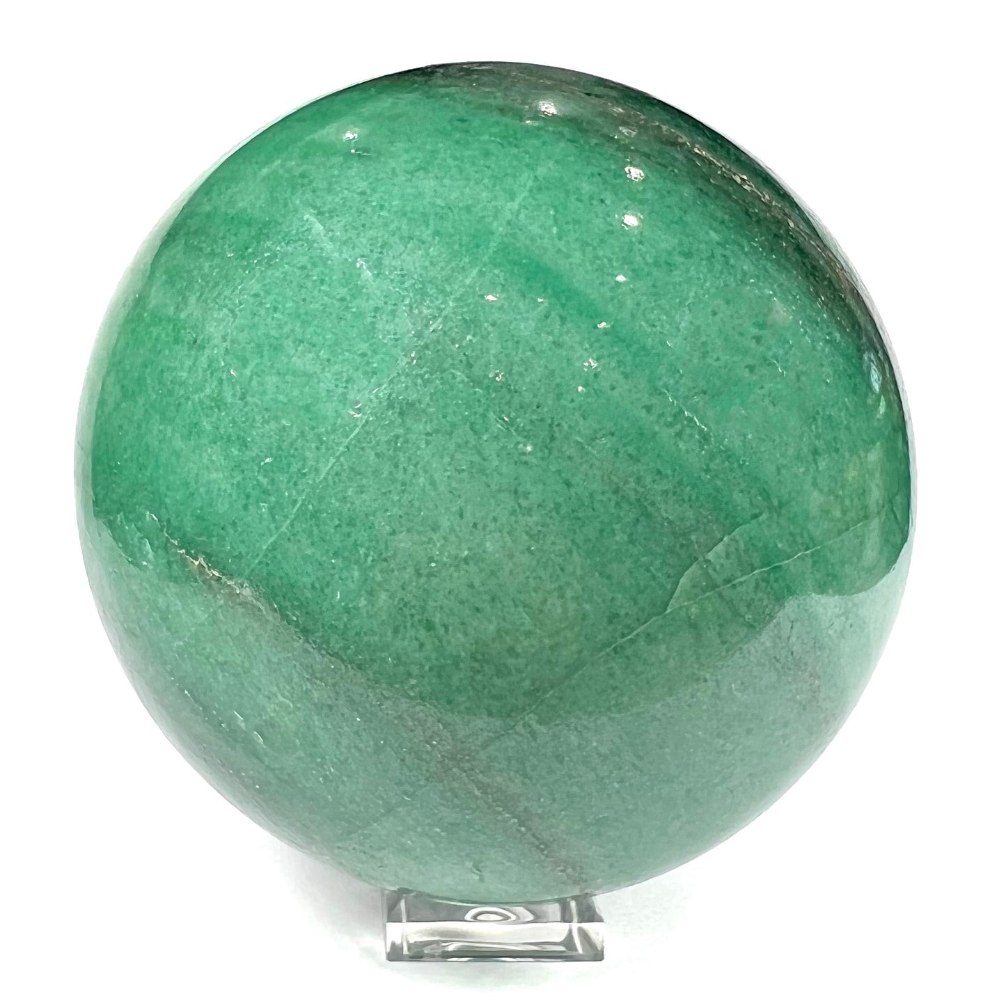 A stone sphere carved from natural green aventurine quartz with containing mica inclusions.