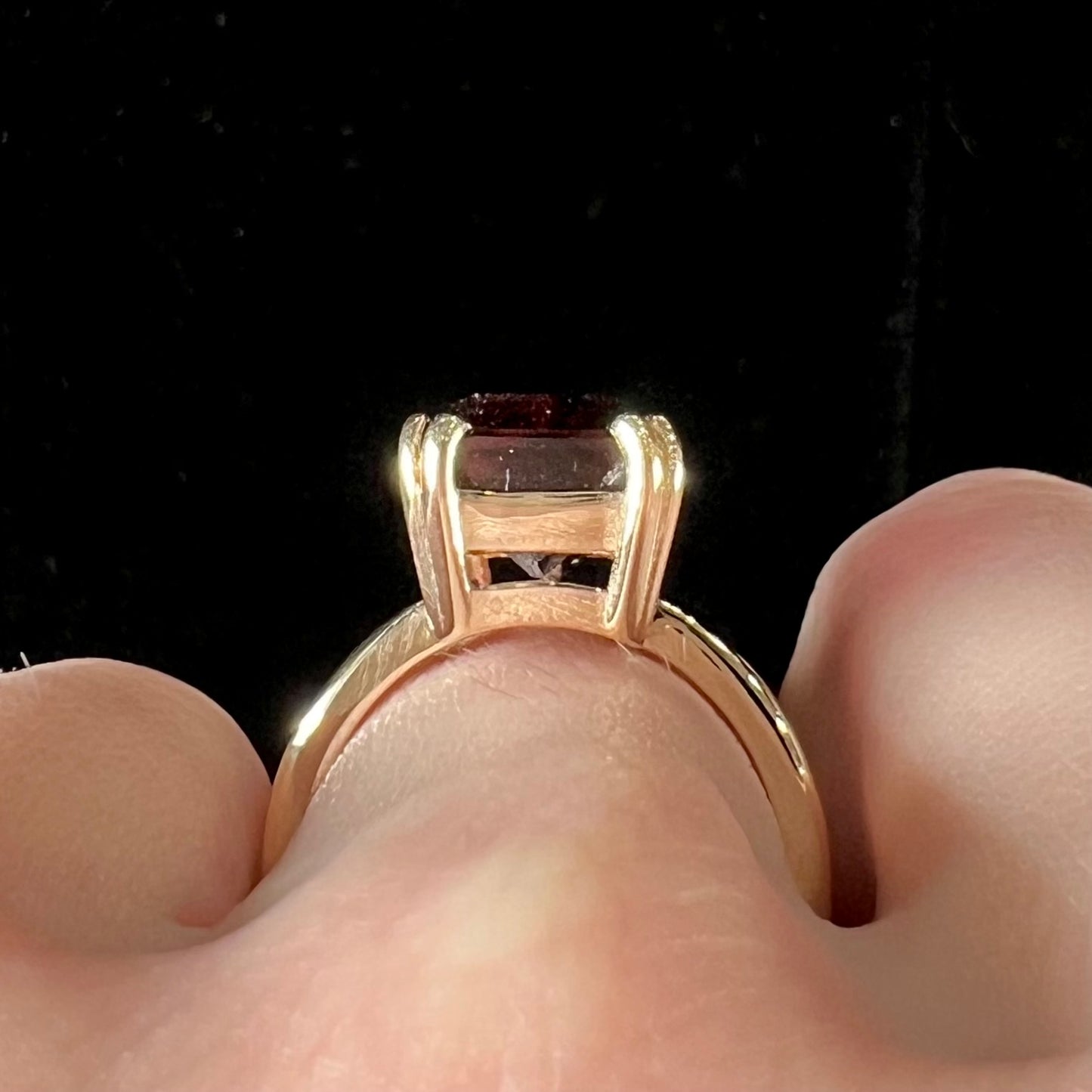 A handmade yellow gold solitaire ring set with a 7.91ct pinkish purple pixel cut tourmaline stone.