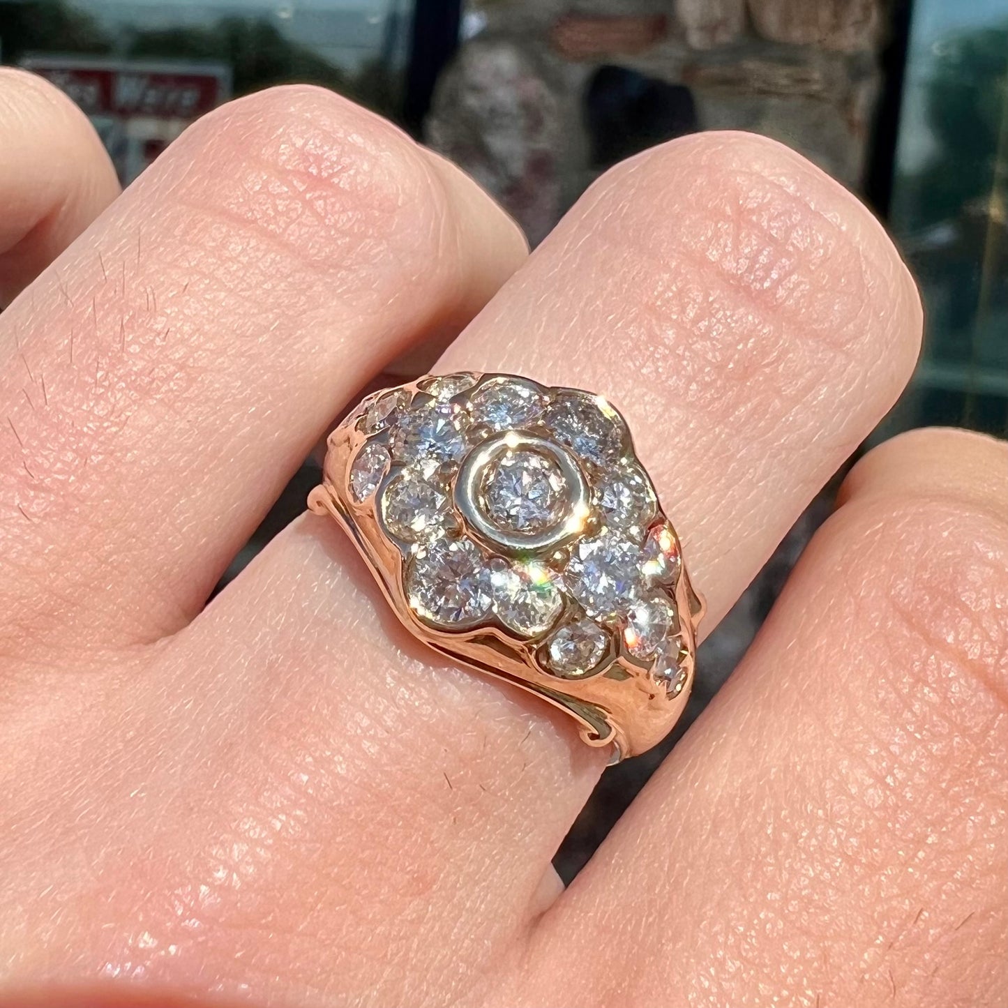 A yellow gold domed diamond ring set with 19 Standard Round Brilliant Cut diamonds.