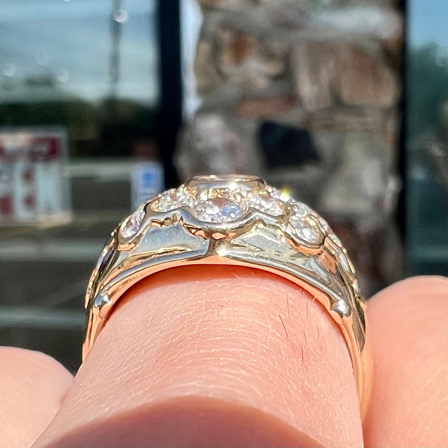 A yellow gold domed diamond ring set with 19 Standard Round Brilliant Cut diamonds.