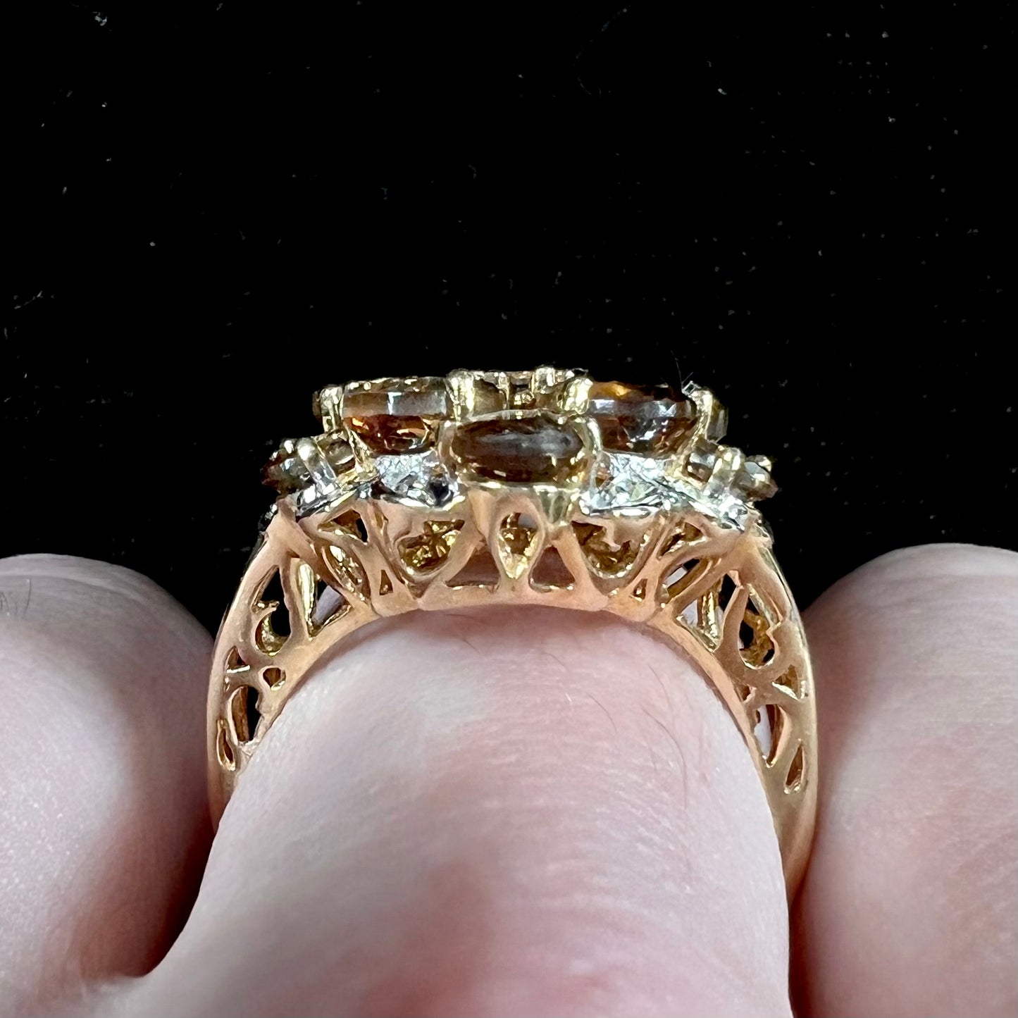 A yellow gold andalusite and diamond cluster ring.
