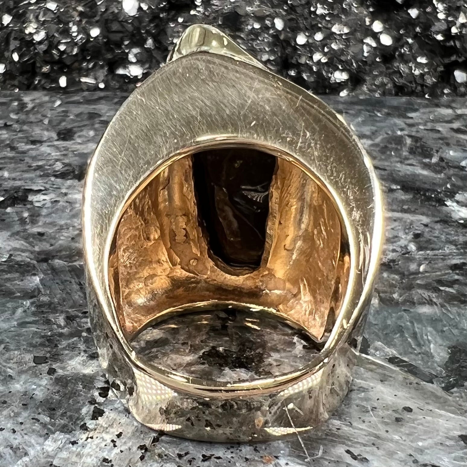 A large nugget style men's fire agate ring cast in yellow gold.  The fire agate is predominantly orange and green.