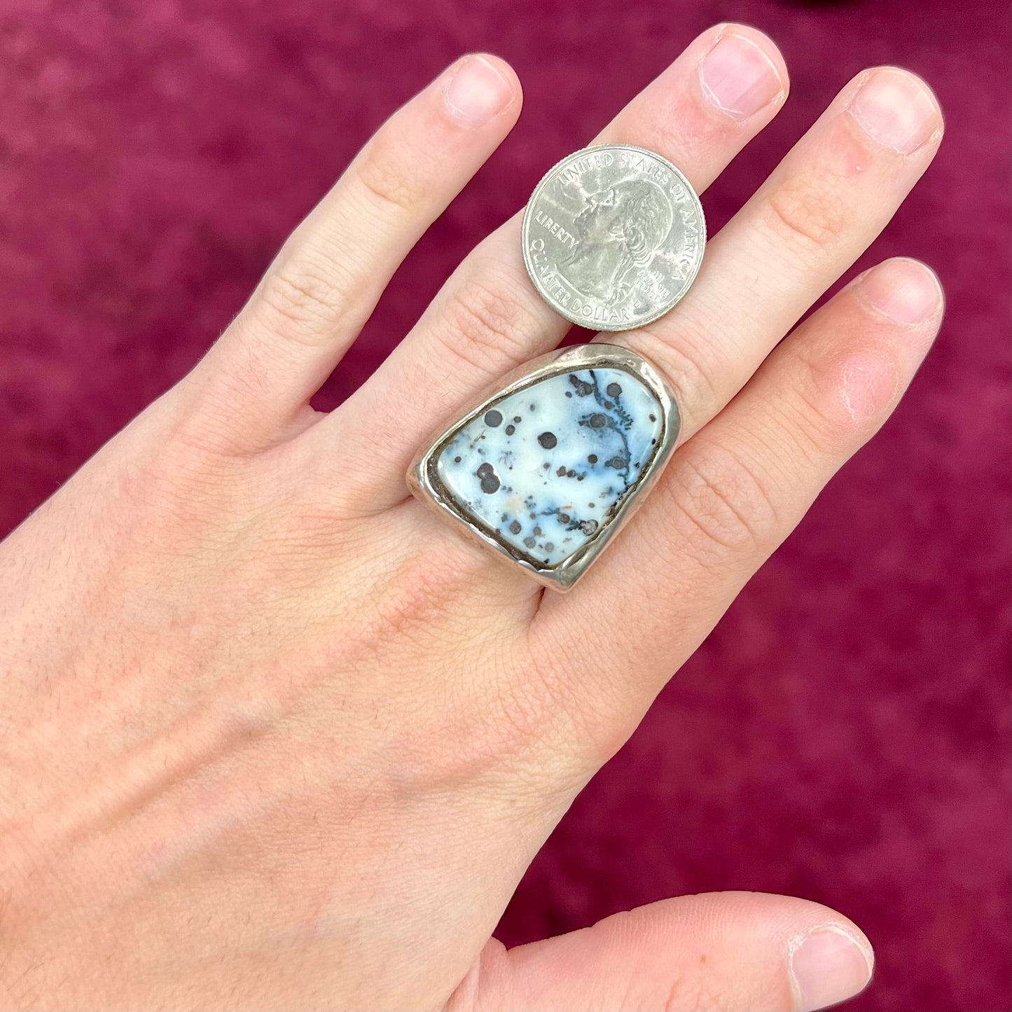 A bezel set ring handmade in sterling silver with a white dendritic agate stone.