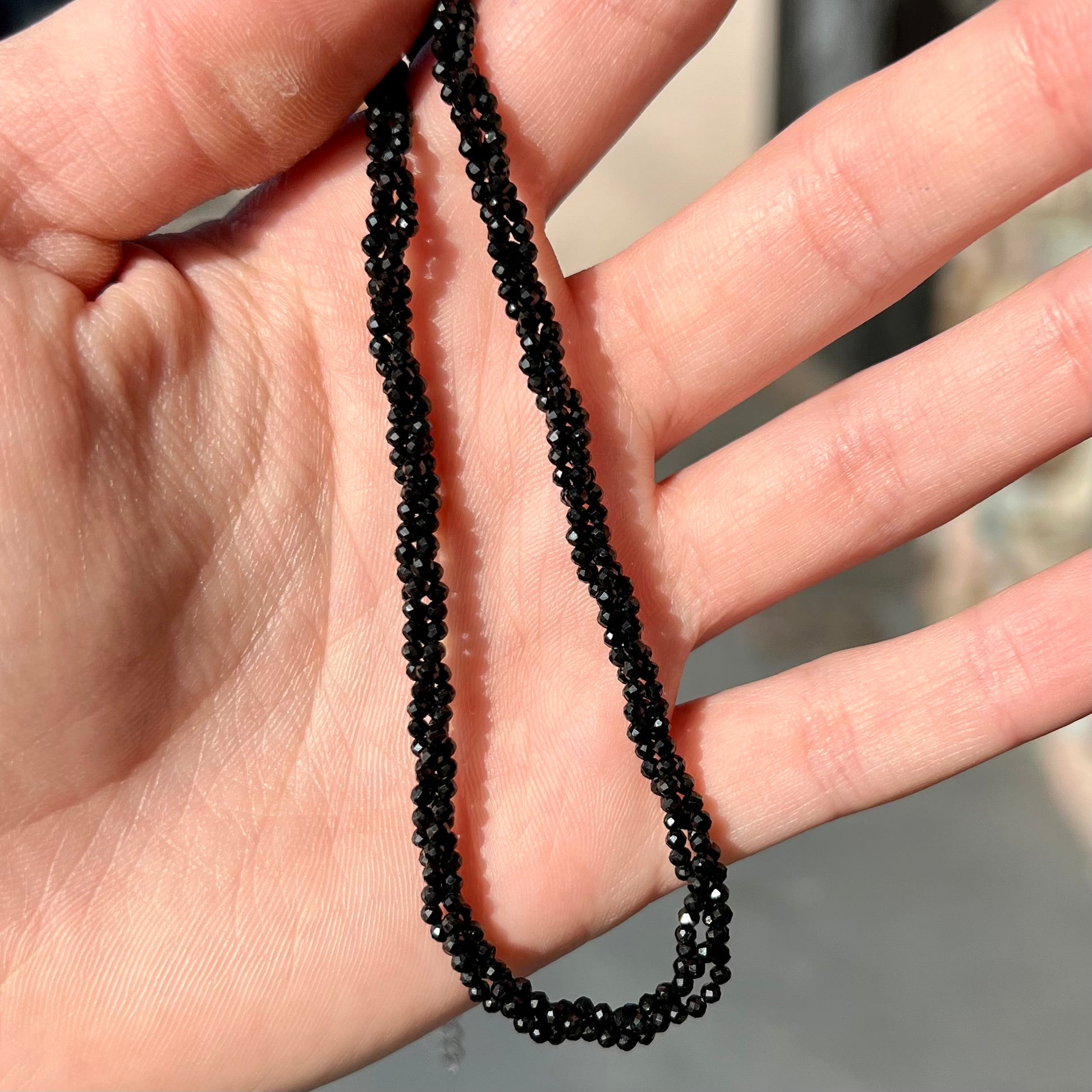 A beaded necklace made of black spinel.