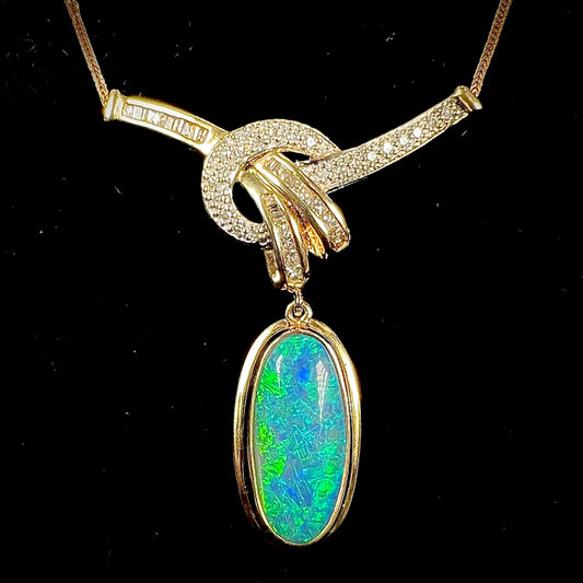 A gold black opal and diamond necklace.  There are round, princess cut, and baguette cut diamonds.