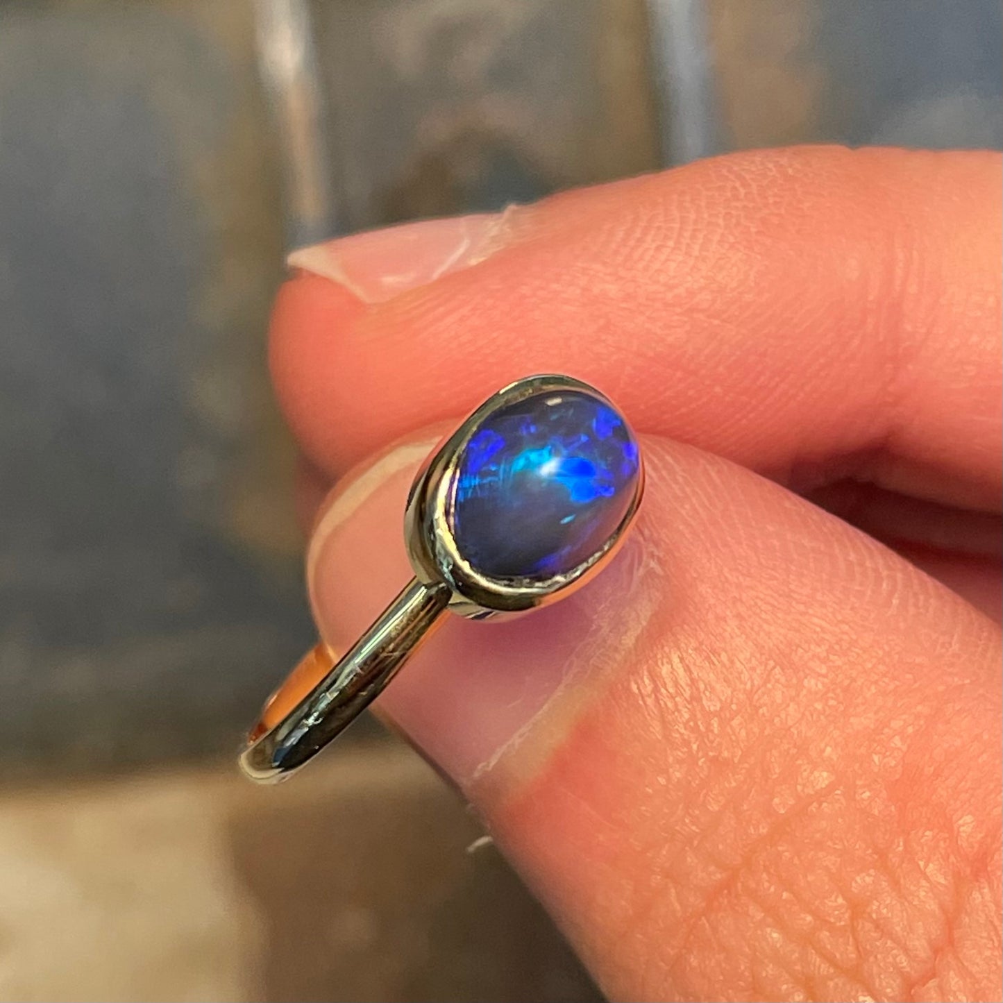 A ladies' black crystal opal solitaire ring set in yellow gold.