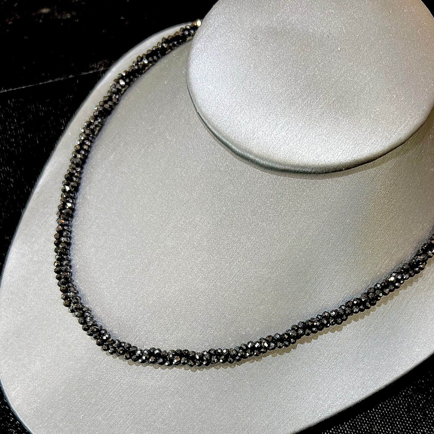 A beaded necklace made of black spinel.