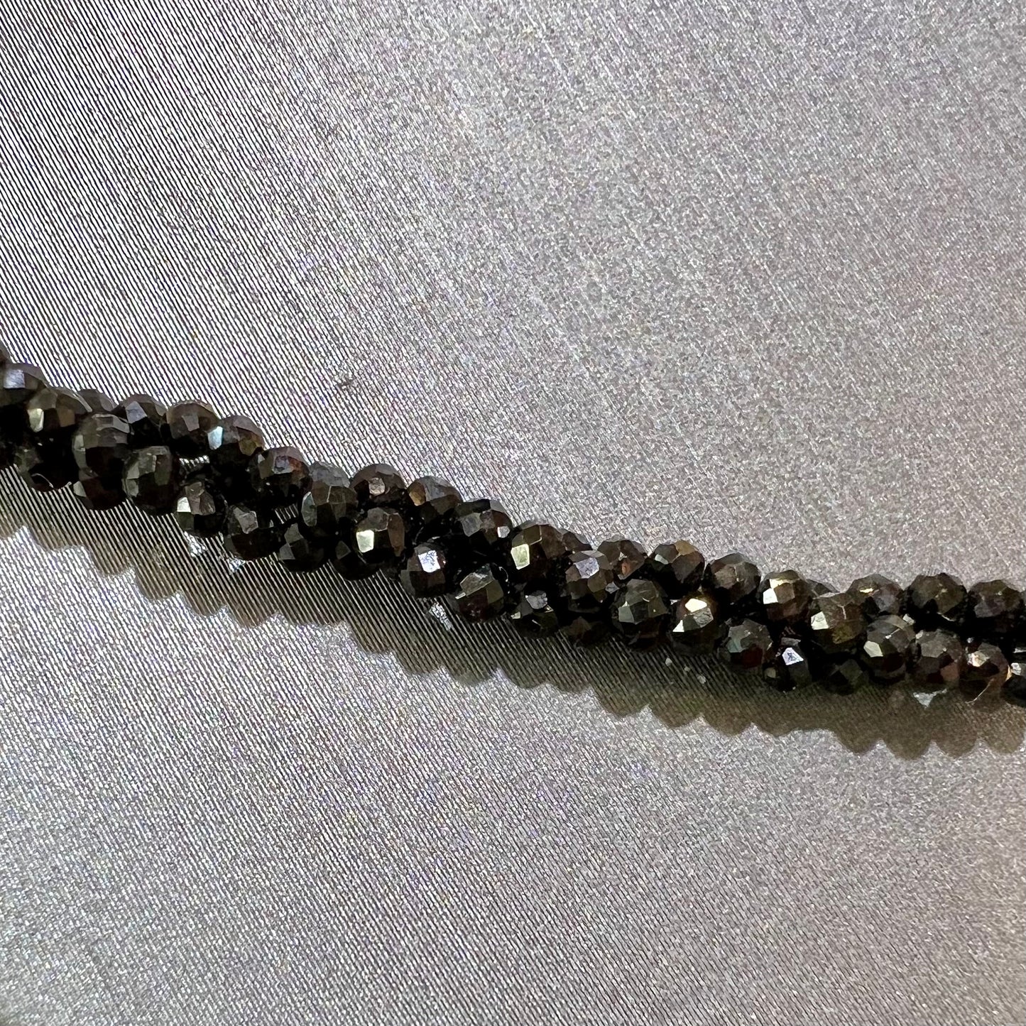 A beaded necklace made of black spinel.