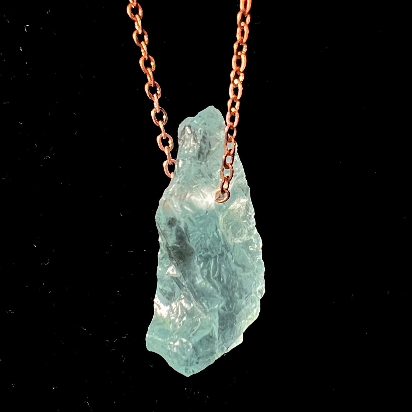 A drilled aquamarine crystal necklace on a copper cable chain.