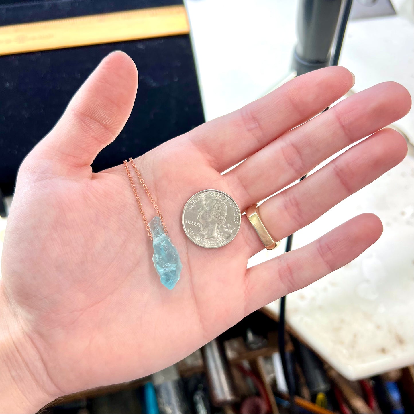 A drilled aquamarine crystal necklace on a copper cable chain.