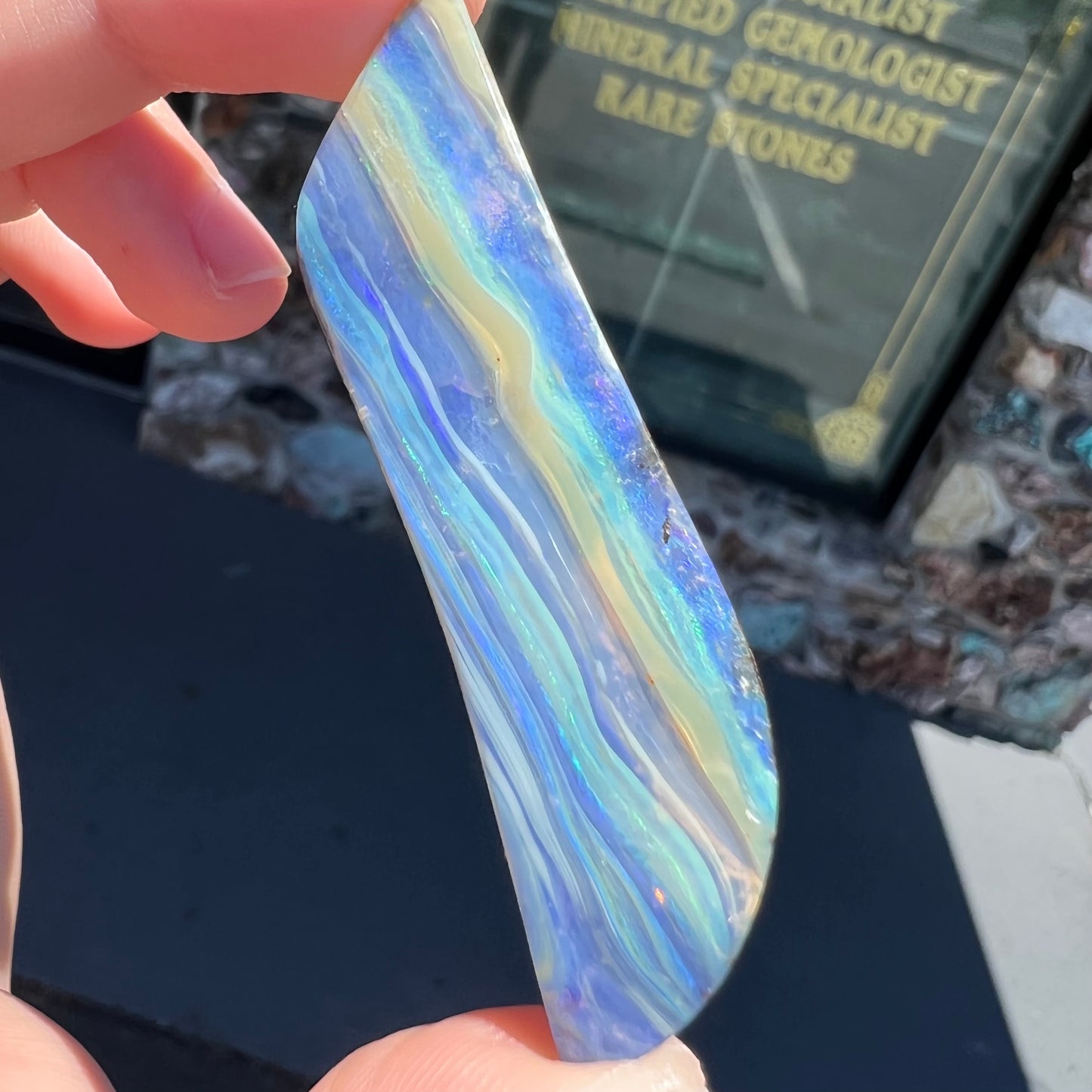 A large, loose, polished Quilpie boulder opal stone from Queensland, Australia. The stone is blue.