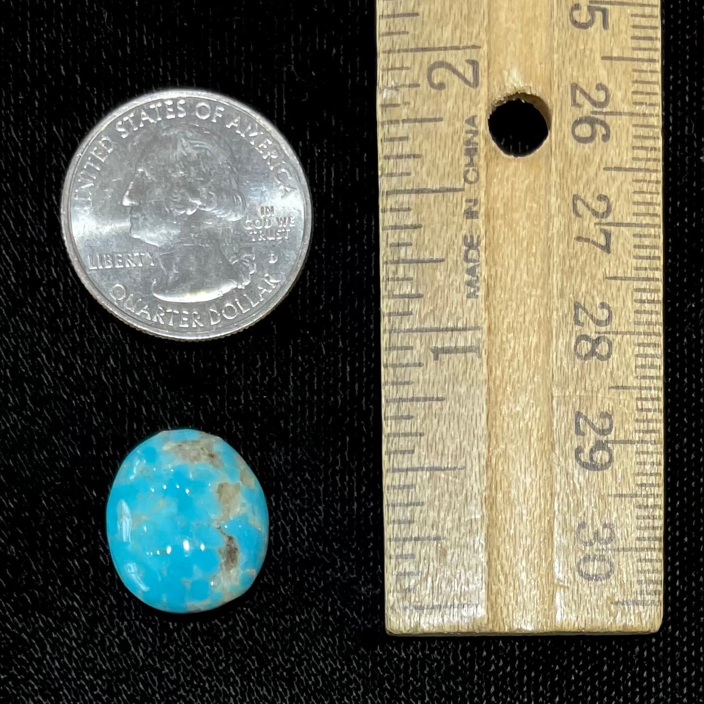 A loose, oval cabochon cut turquoise stone from the Sleeping Beauty Mine in Arizona.