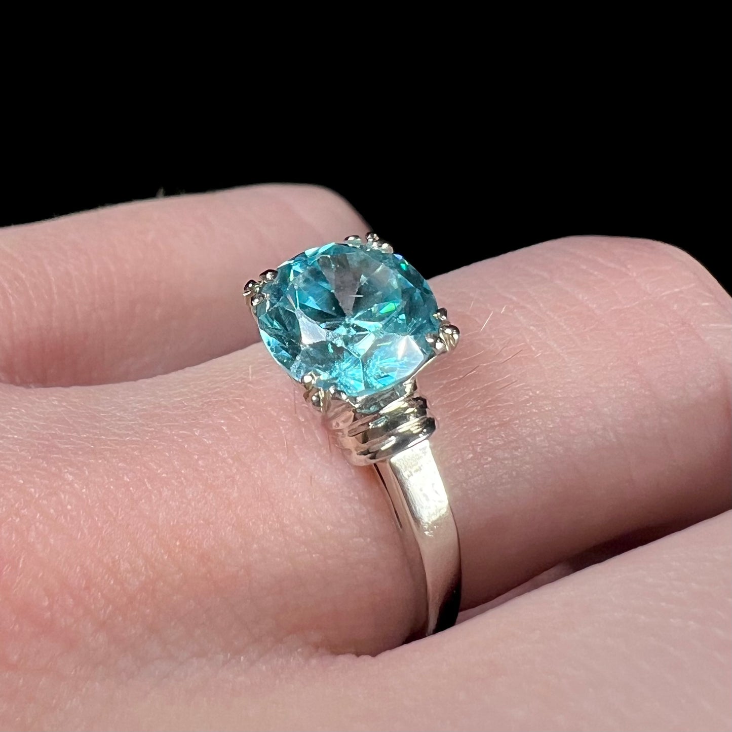 A ladies' vintage white gold solitaire ring set with a round brilliant cut blue zircon stone.