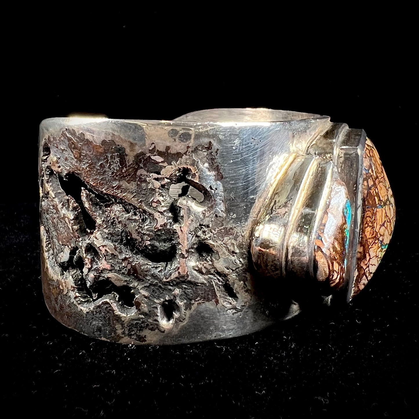 A men's sterling silver and copper infused cuff bracelet set with two boulder opal stones from Koroit, Australia.
