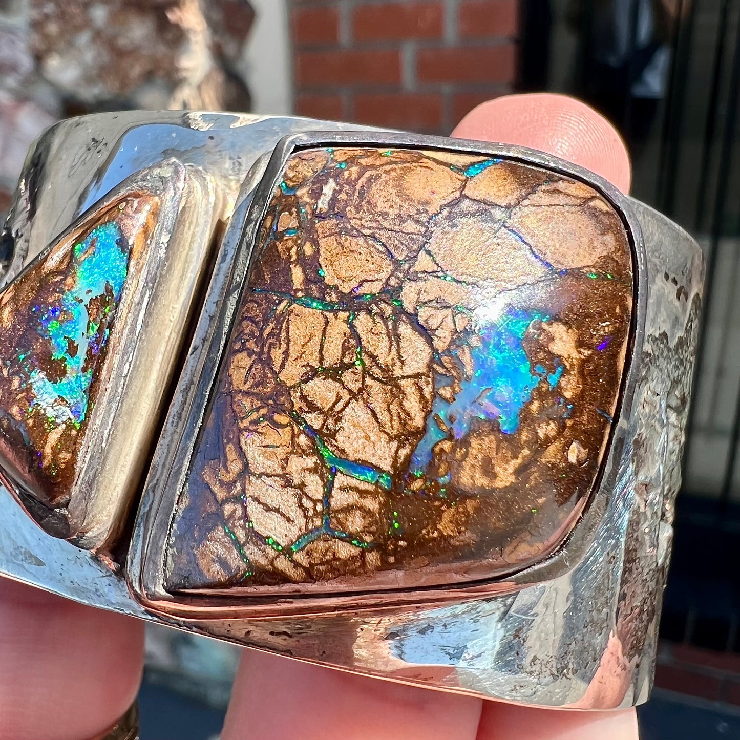 A men's sterling silver and copper infused cuff bracelet set with two boulder opal stones from Koroit, Australia.