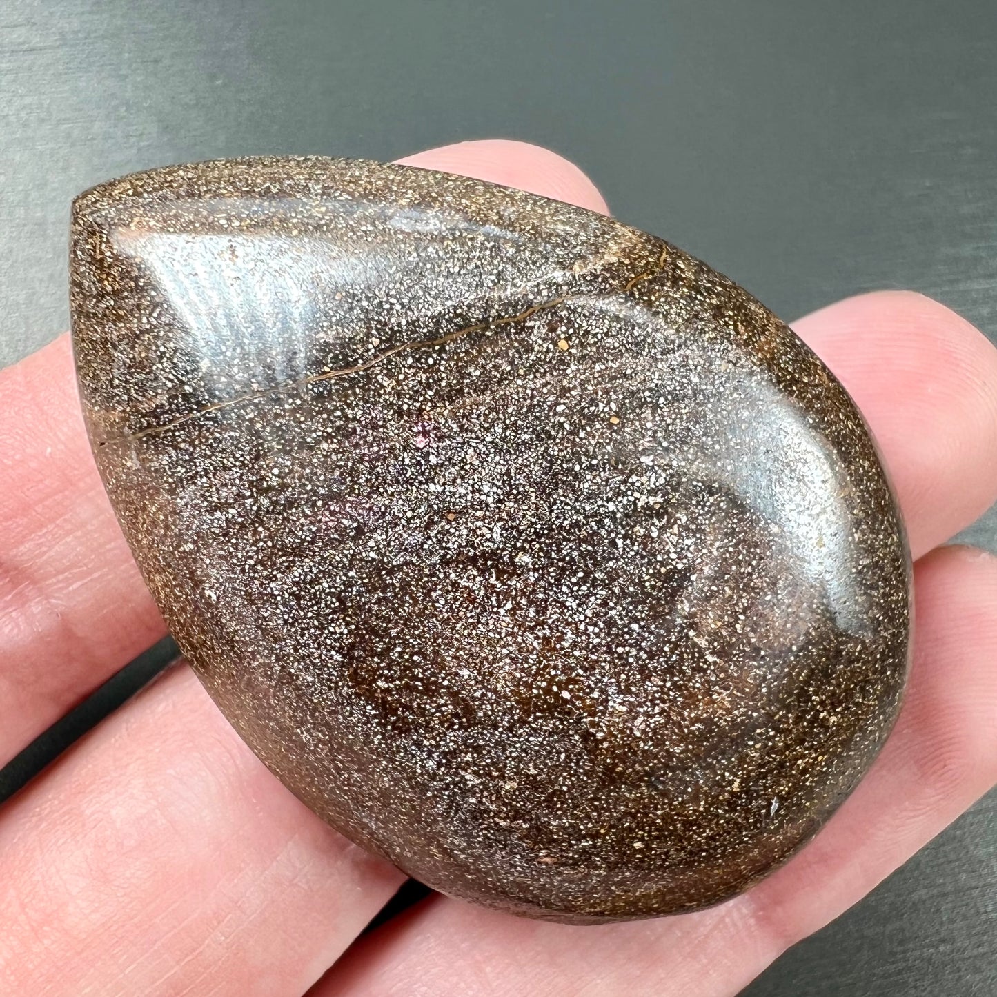 A loose, polished Quilpie boulder opal stone from Queensland, Australia. The opal displays a blue flow pattern.