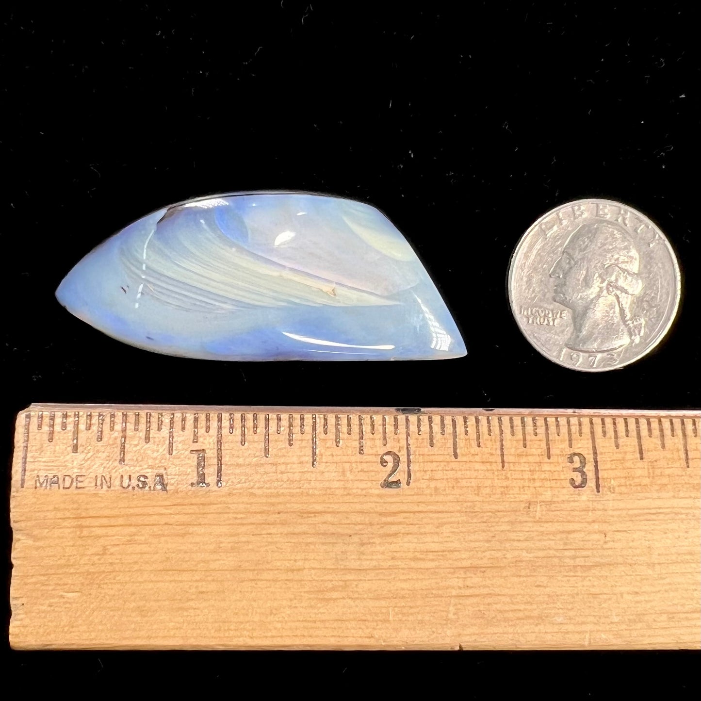 A loose, polished blue boulder opal stone from Queensland, Australia.