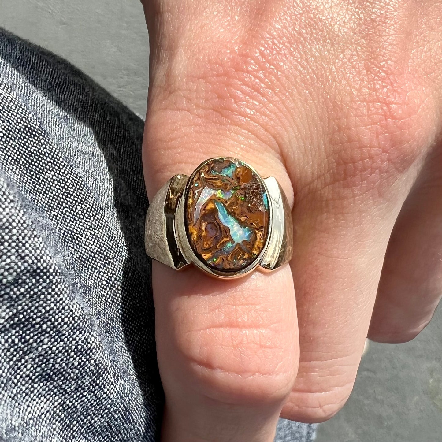 A Koroit boulder opal men's ring in brushed yellow gold.