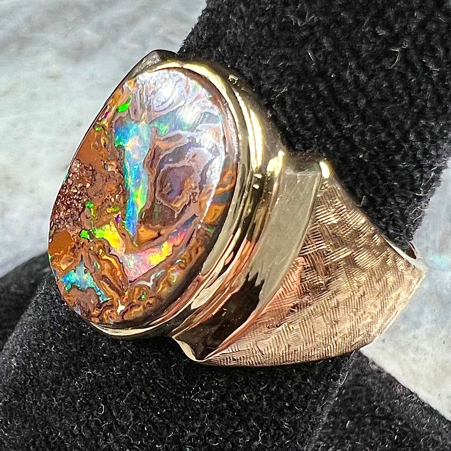 A Koroit boulder opal men's ring in brushed yellow gold.