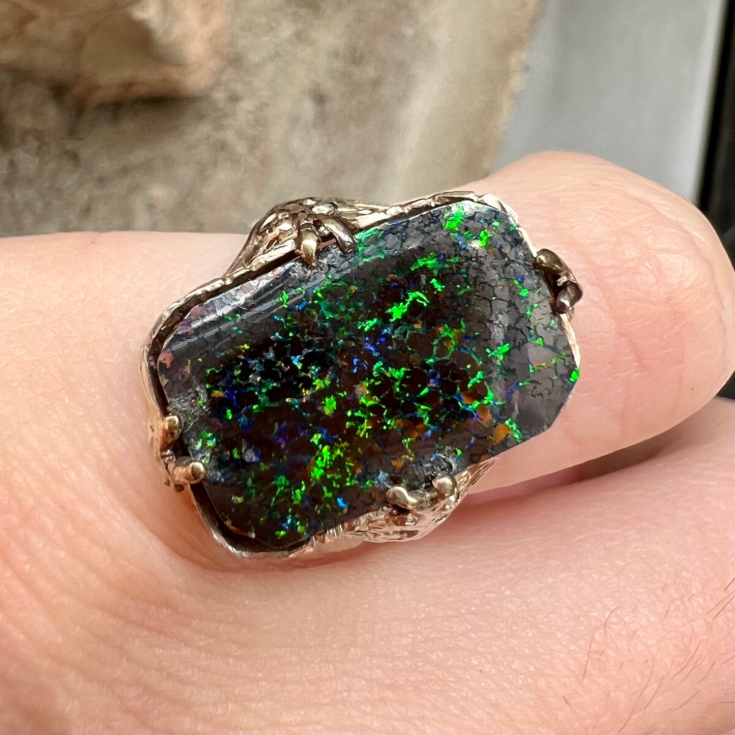 A vintage, white gold filigree unisex ring set with a black Koroit boulder opal.